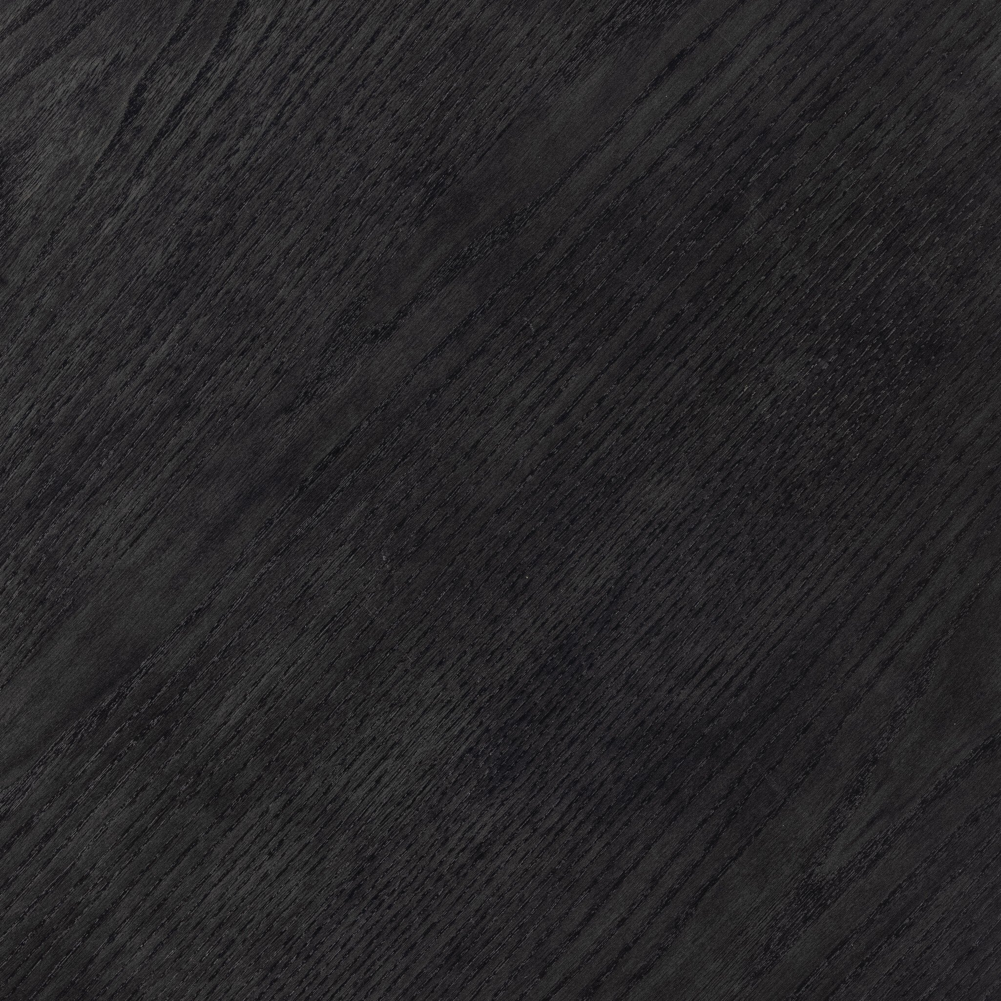 Close up of the black-washed solid ash table showing its dark color and wood grain. 