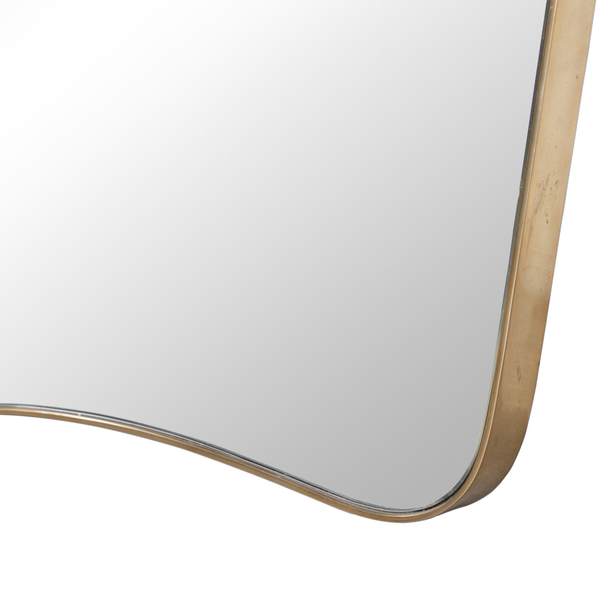 Close up of a decorative wall mirror with a gold frame on a white background.