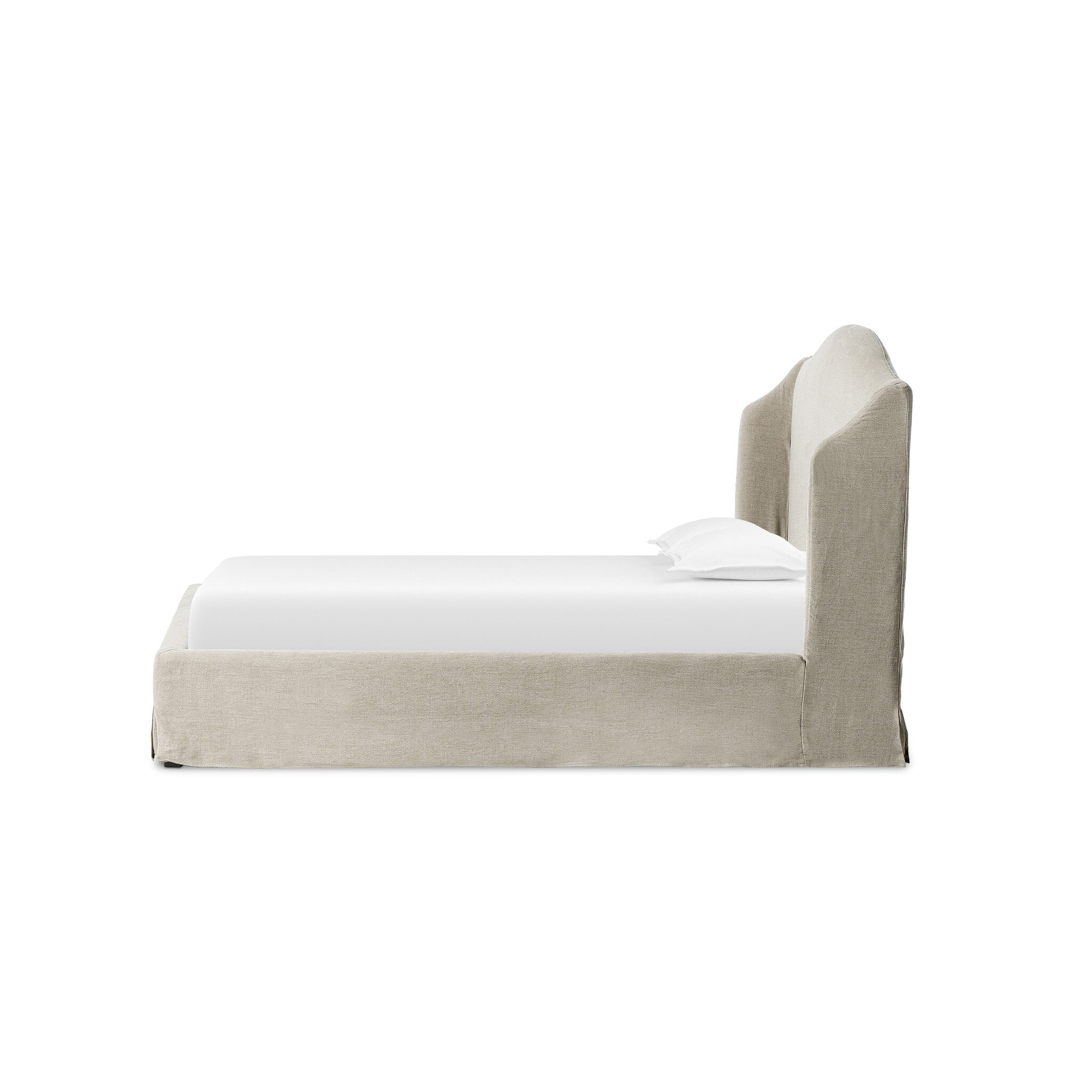 Side profile of a beige upholstered bed with white bedding on a white background.