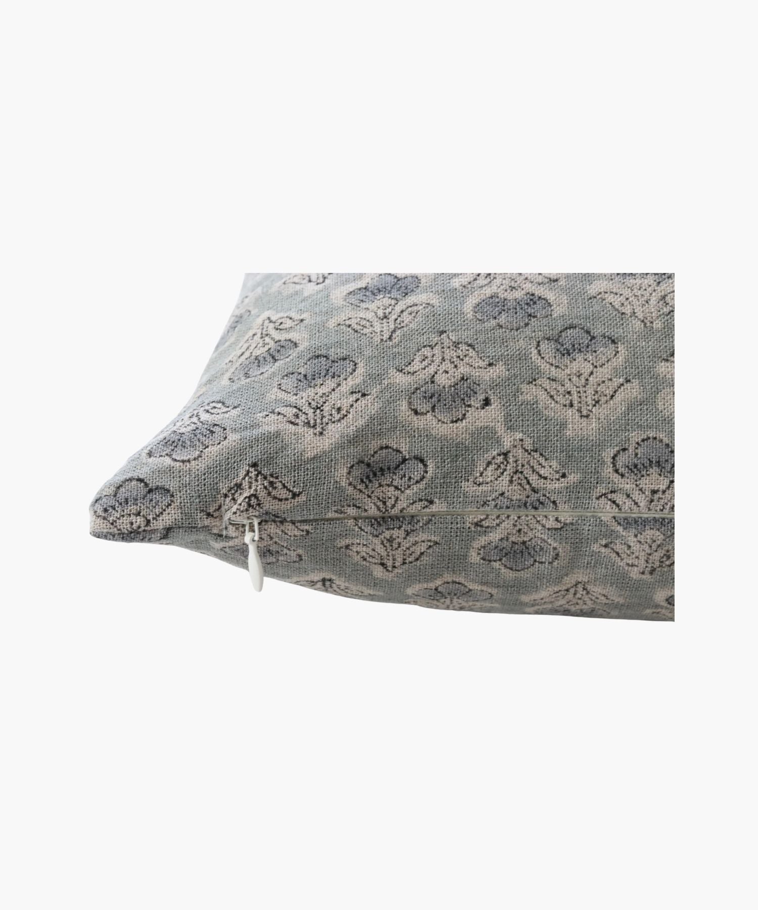 A close up of a pillow with a subtle, intricate floral pattern in muted blue and gray tones. The design is elegant, conveying a calm and cozy atmosphere. | Wildwood Home Co.