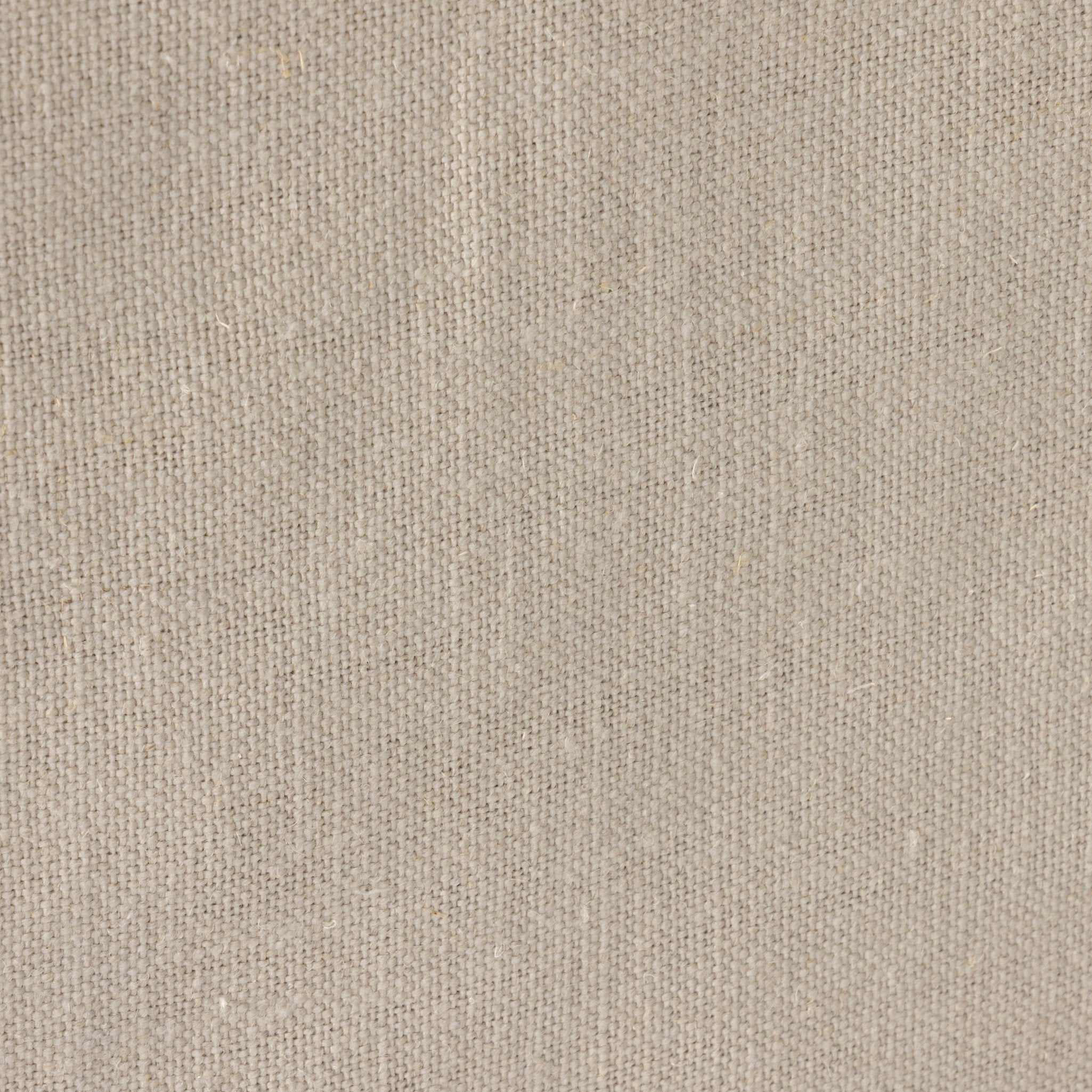 Close up of a traditional swivel chair with an ivory slipcover on a white background. 