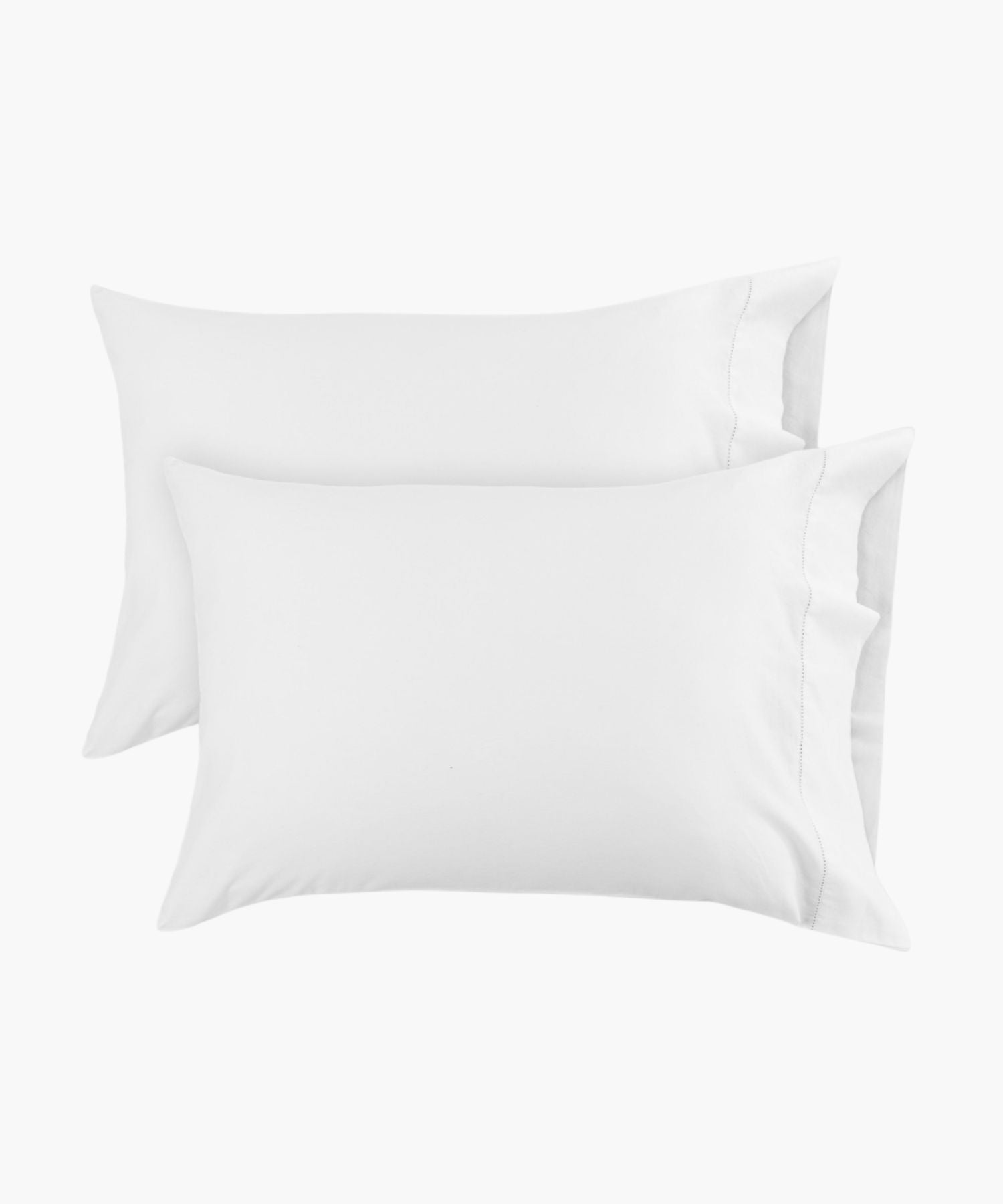 Standard white pillowcases shown in a flat lay against a white background, with a hemstitch detail near the edge adding a subtle, tailored finish. | Wildwood Home Co.