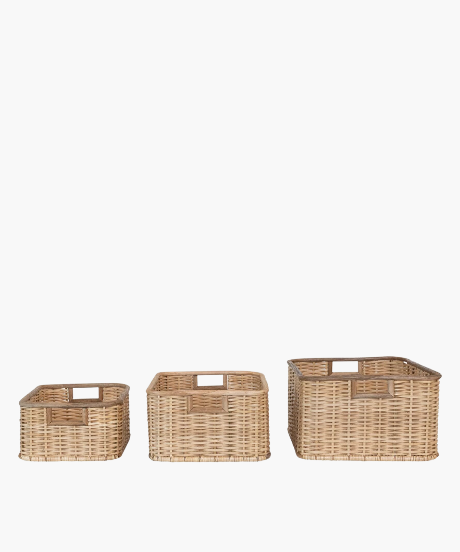 Three square wicker baskets in various sizes with natural woven texture, two square cut-out handles. The earthy tone conveys a rustic, homely, and practical feel. | Wildwood Home Co.