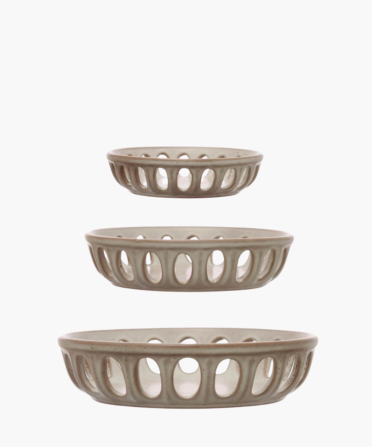 Three beige ceramic basket bowls with open oval patterns are arranged vertically. Each basket is slightly larger than the one above it, creating a harmonious tiered effect. | Wildwood Home Co.