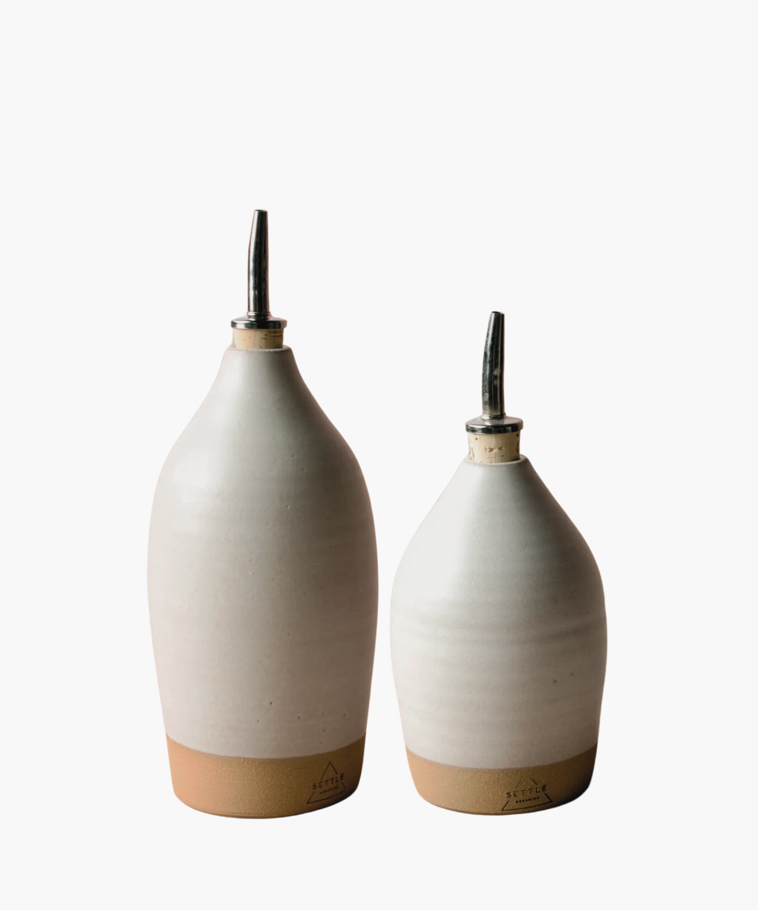 18-20oz and 14oz ceramic bottles with an off white matte finish, topped with a metal spout. It conveys a minimalist and elegant tone. | Wildwood Home Co.