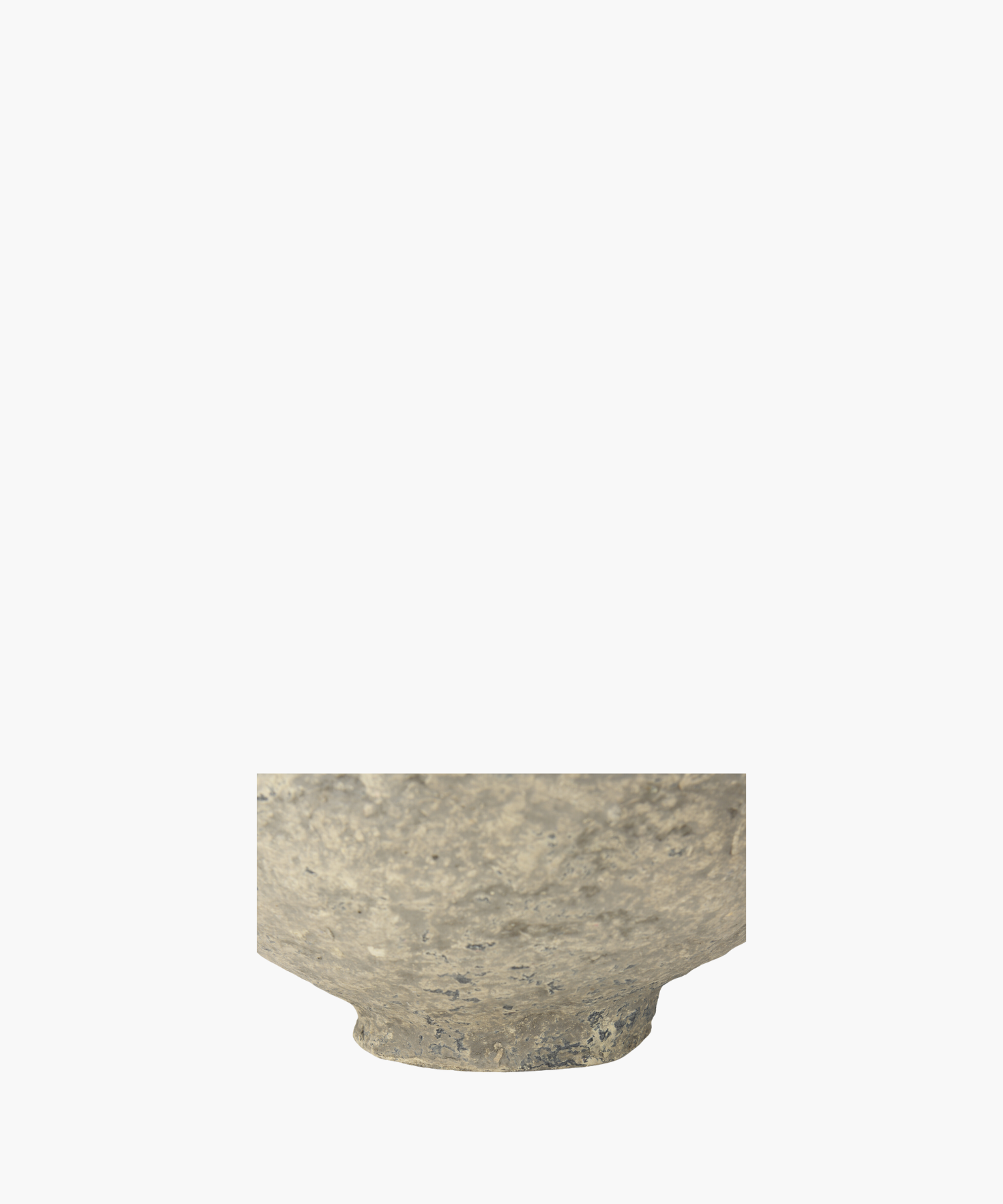 A detailed picture of a rustic, paper mache bowl highlighting the textured surface, showcasing shades of gray and subtle patches of darker tones. The bowl exudes an ancient, historical feel.