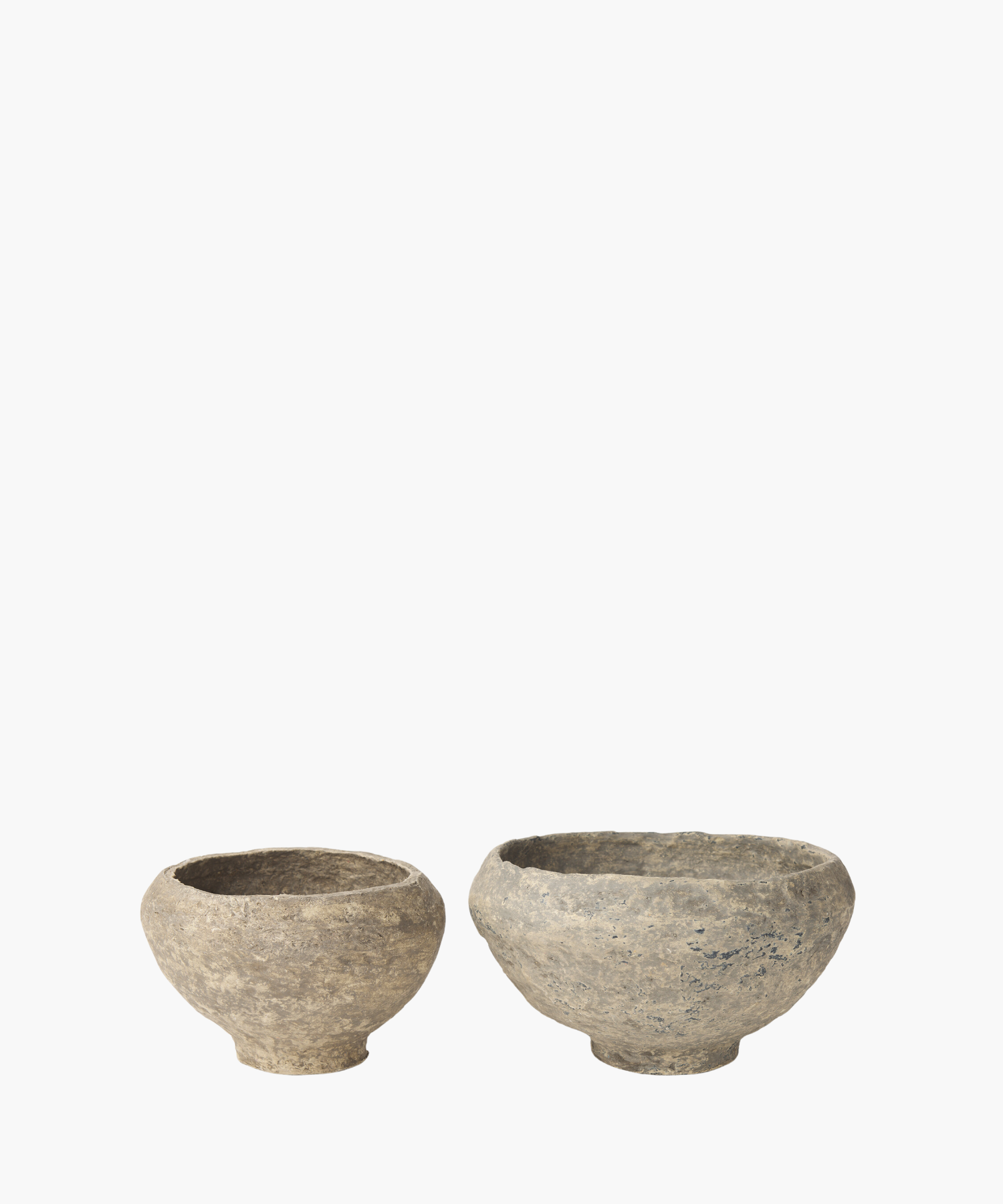 Two rustic, paper mache bowls in various sizes with a textured surface, showcasing shades of gray and subtle patches of darker tones. The bowl exudes an ancient, historical feel.