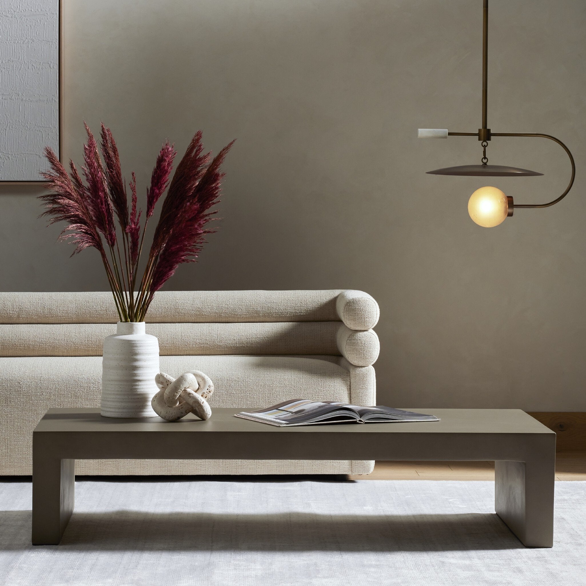 Modern living room with a beige sofa, coffee table, and decorative elements. | Wildwood Home Co.