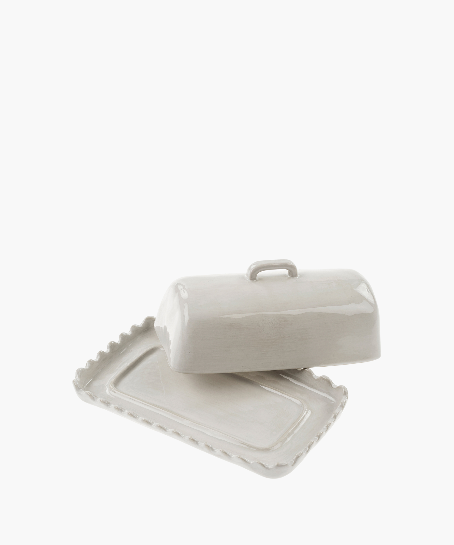 White ceramic butter dish with a lifted lid revealing a scalloped edge base. The glossy finish and simple design convey elegance and functionality. | Wildwood Home Co.