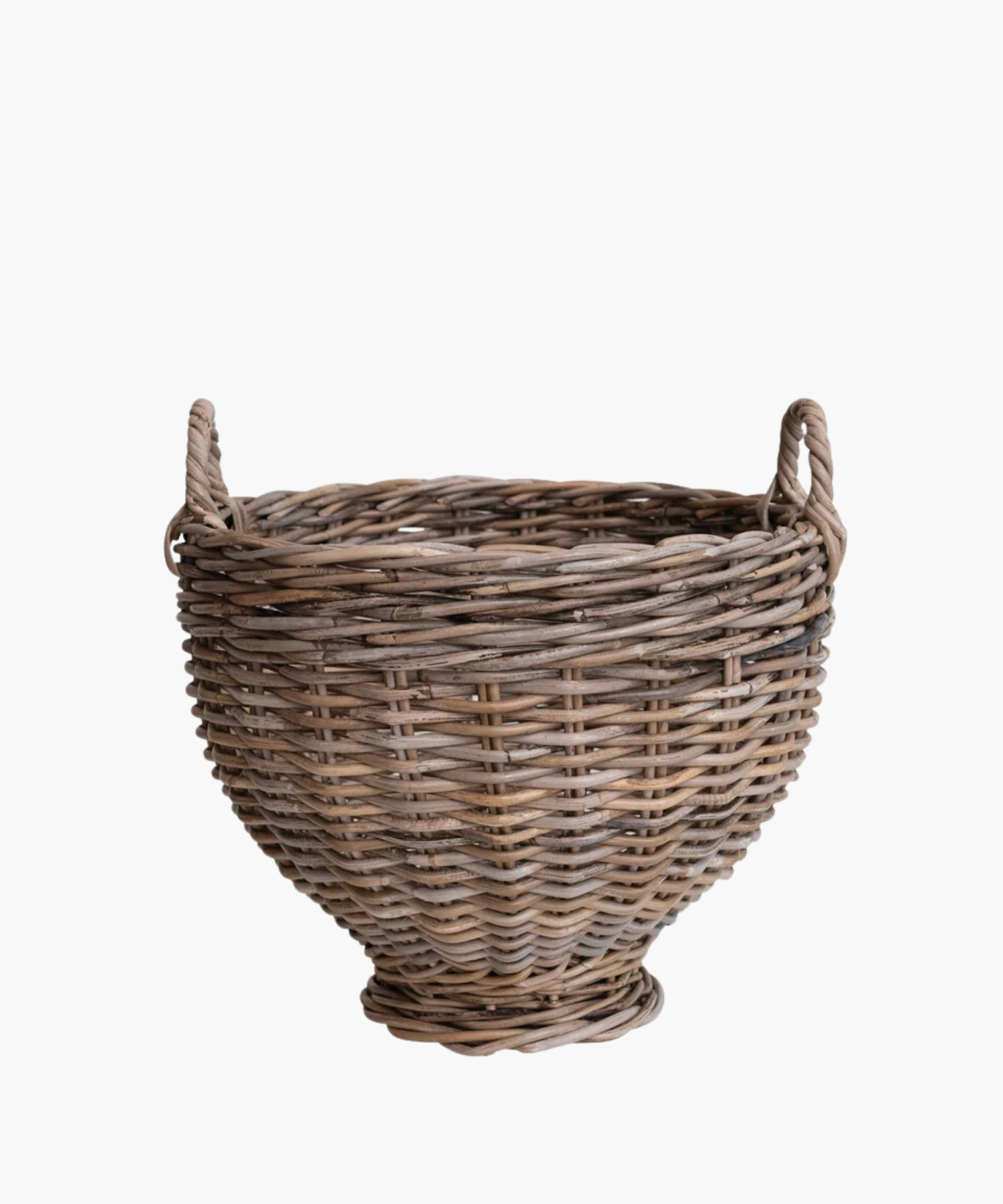 A handwoven round rattan footed basket with two small handles, featuring a natural brown tone. The basket has a rustic, handcrafted appearance, conveying a traditional and homely feel. | Wildwood Home Co. 