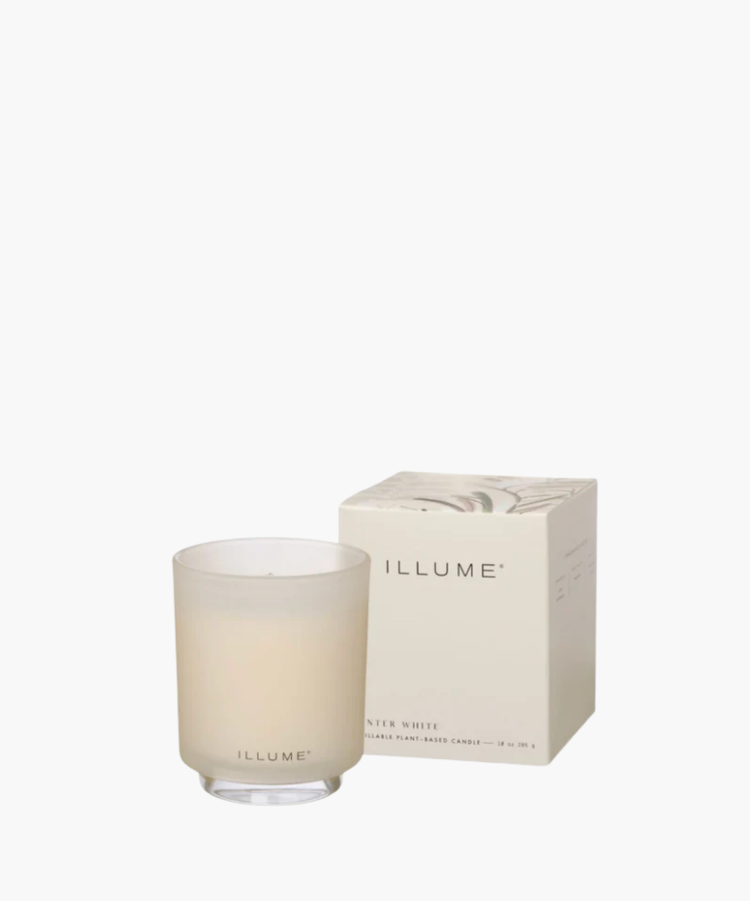 Frosted glass candle with "ILLUME" branding beside a matching decorated box. Soft, elegant design conveys a sense of calm and sophistication.
