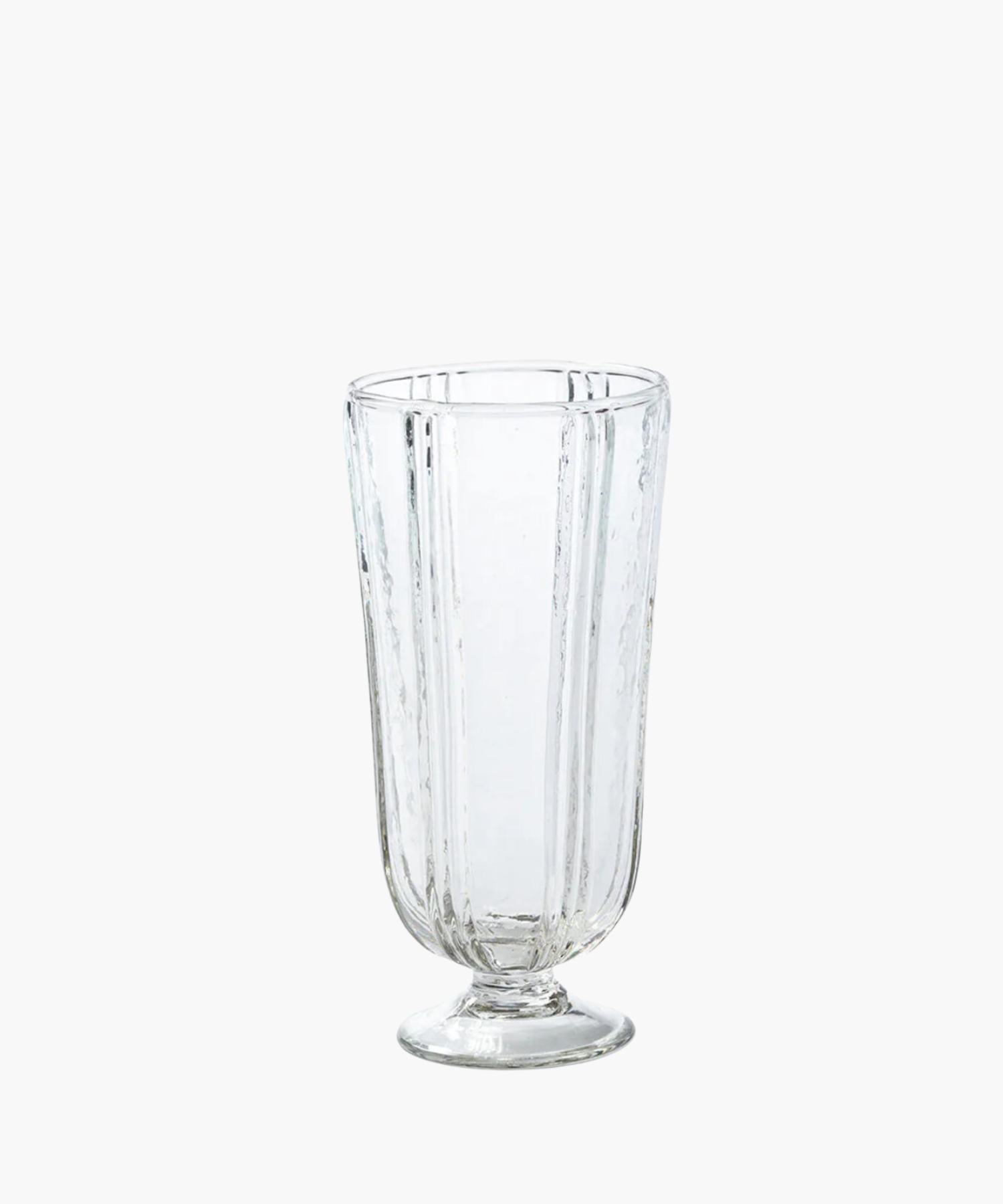 Clear glass tumbler with a textured, vertical ripple pattern. The glass is set on a short pedestal base, conveying a classic and elegant tone. | Wildwood Home Co.