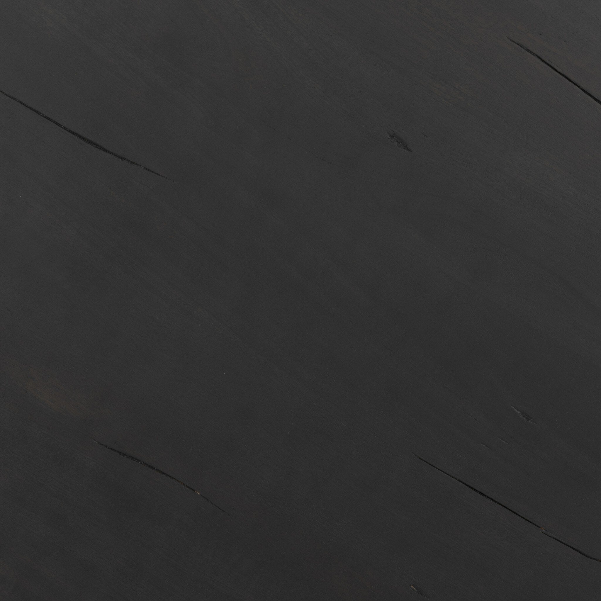 A close up picture of the black end table showing its color and subtle wood grain.