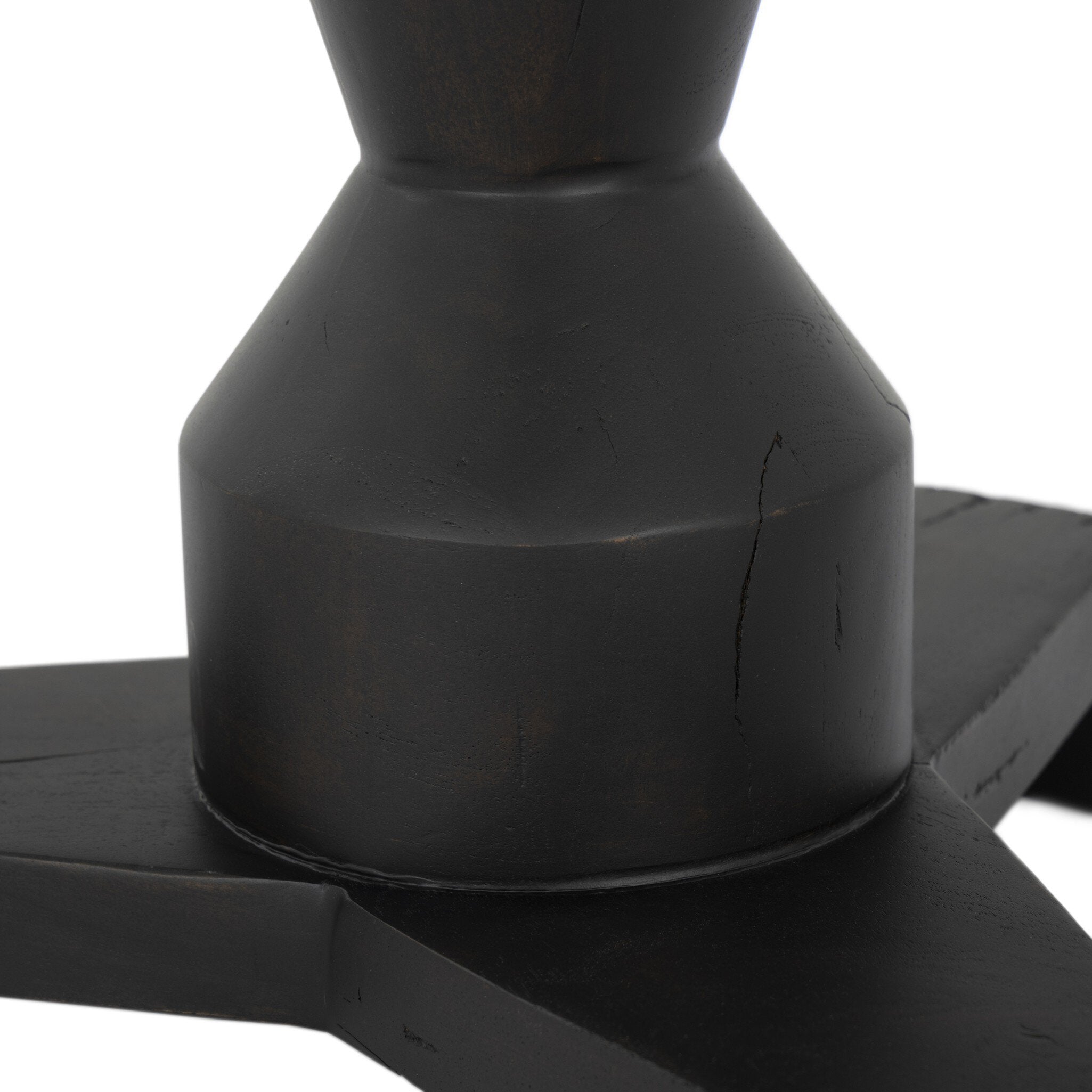 Close up of the a pedestal base showing its sculptural shape on a white background.