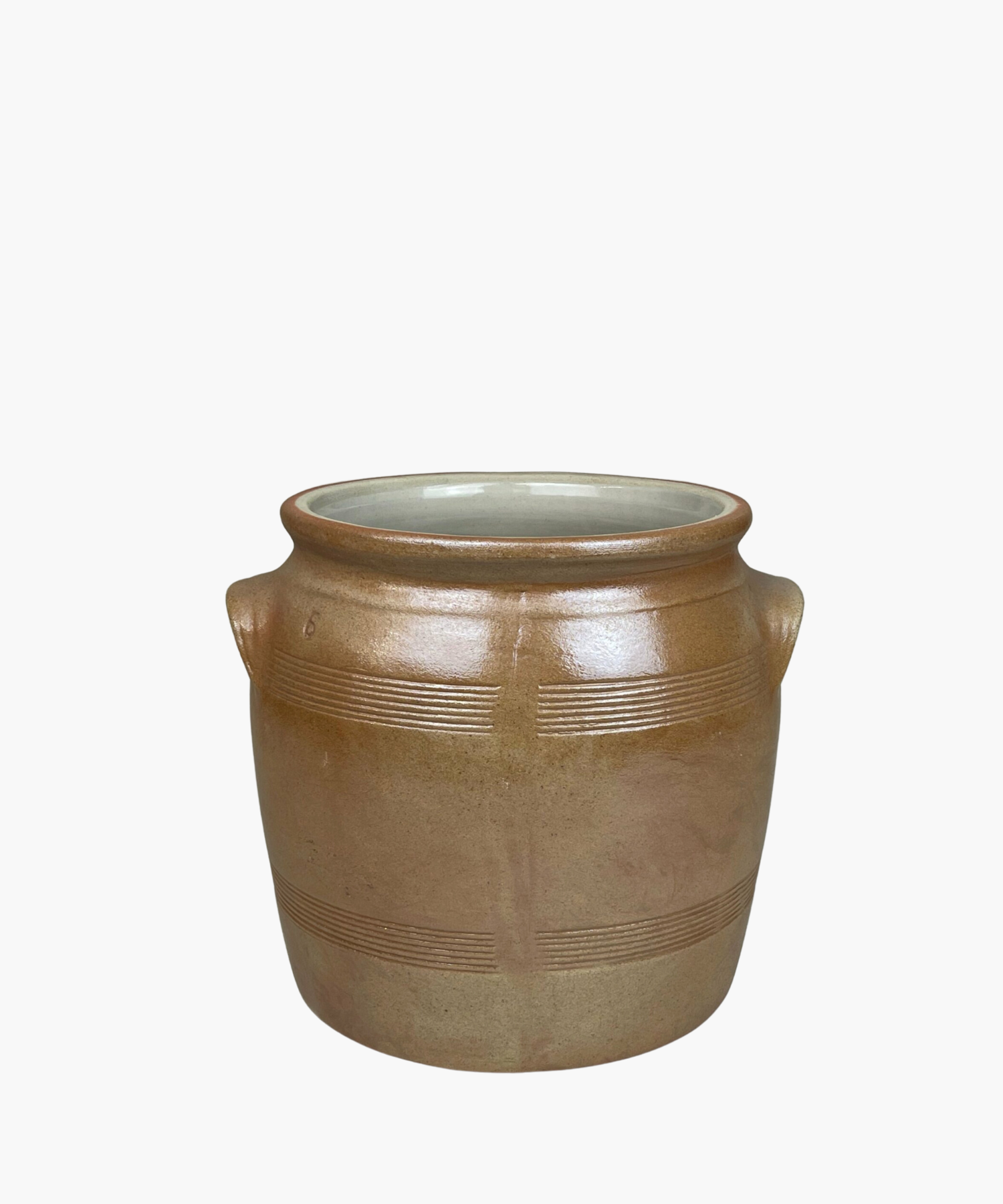 A rustic, brown salt crock with two small handles and horizontal etched lines. The pot has a smooth finish, conveying a simple, earthy elegance.