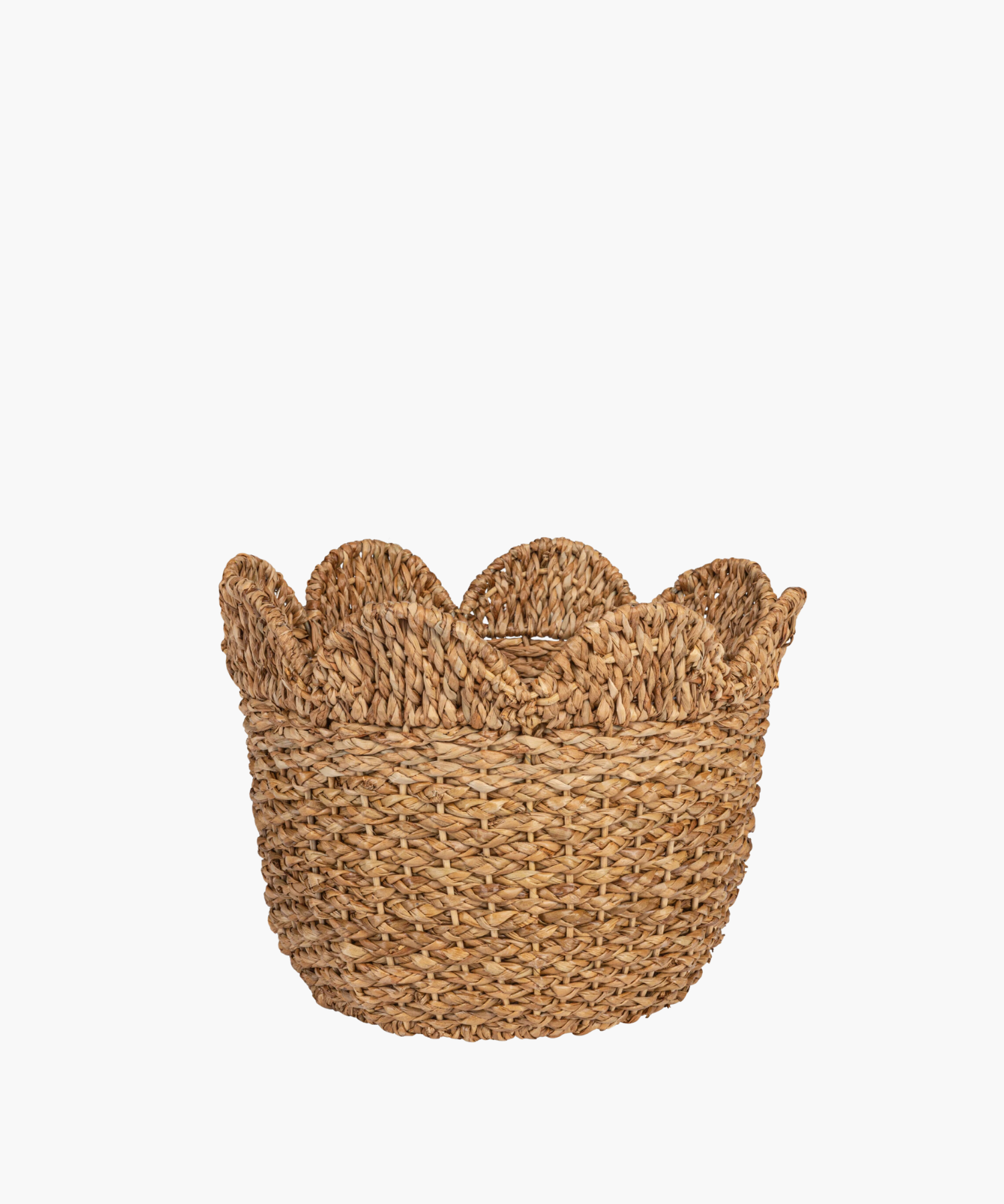 Woven basket with a scalloped edge in natural straw color. The texture is coarse, conveying a rustic and earthy tone. | Wildwood Home Co.