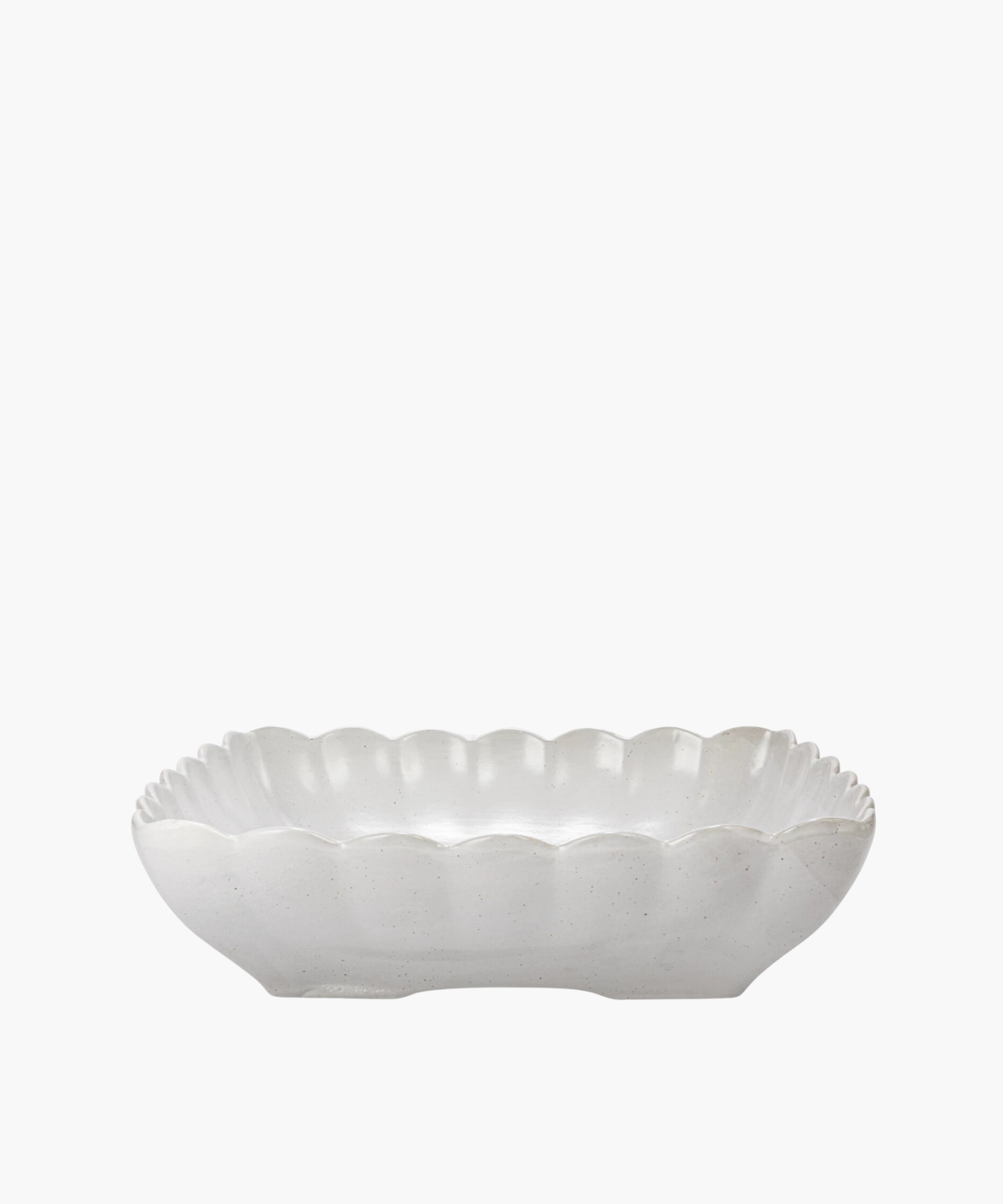 A white ceramic dish with scalloped edges and a subtle, glossy finish. The dish is empty and set against a plain white background. | Wildwood Home Co.