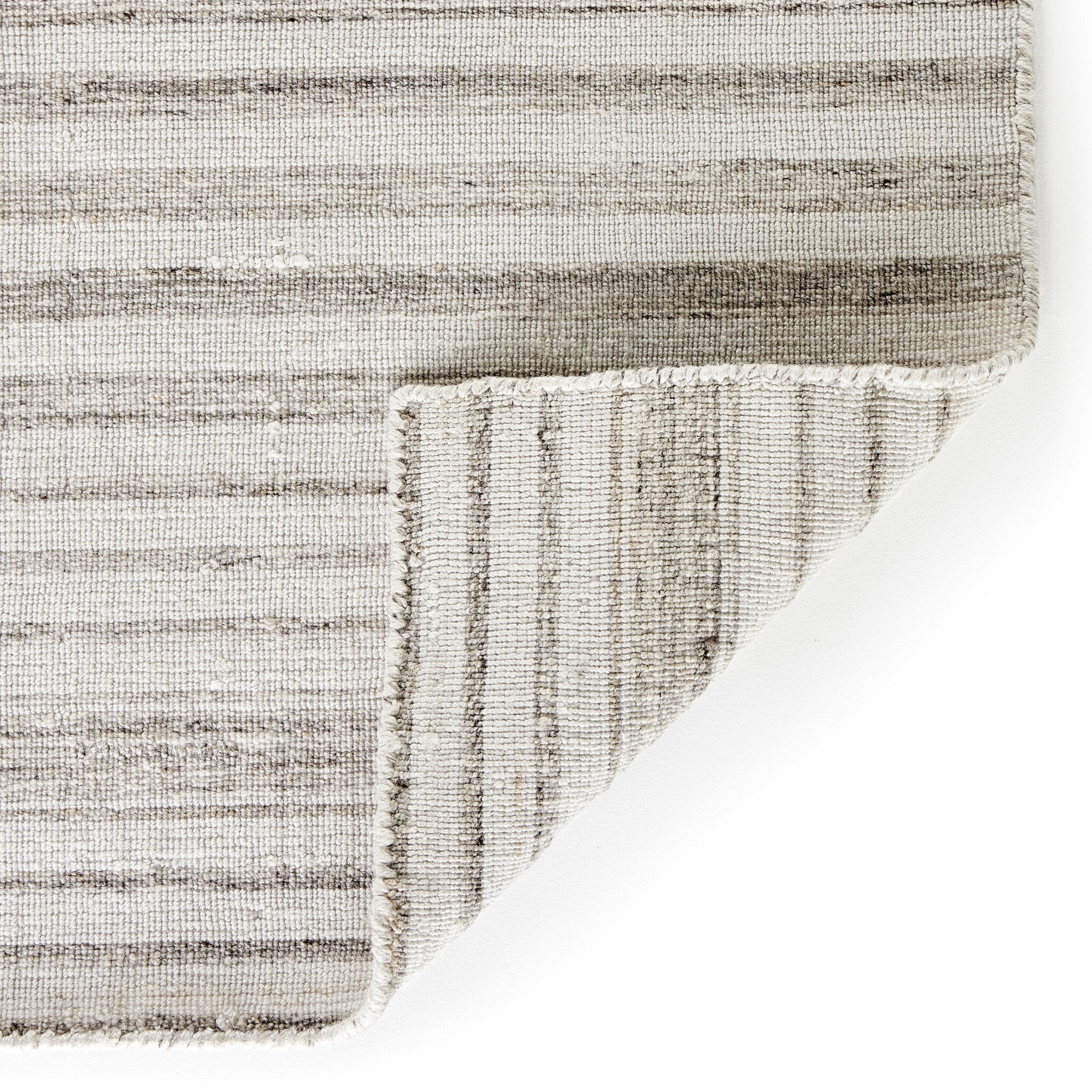Rectangular rug with a striped pattern on a white background.