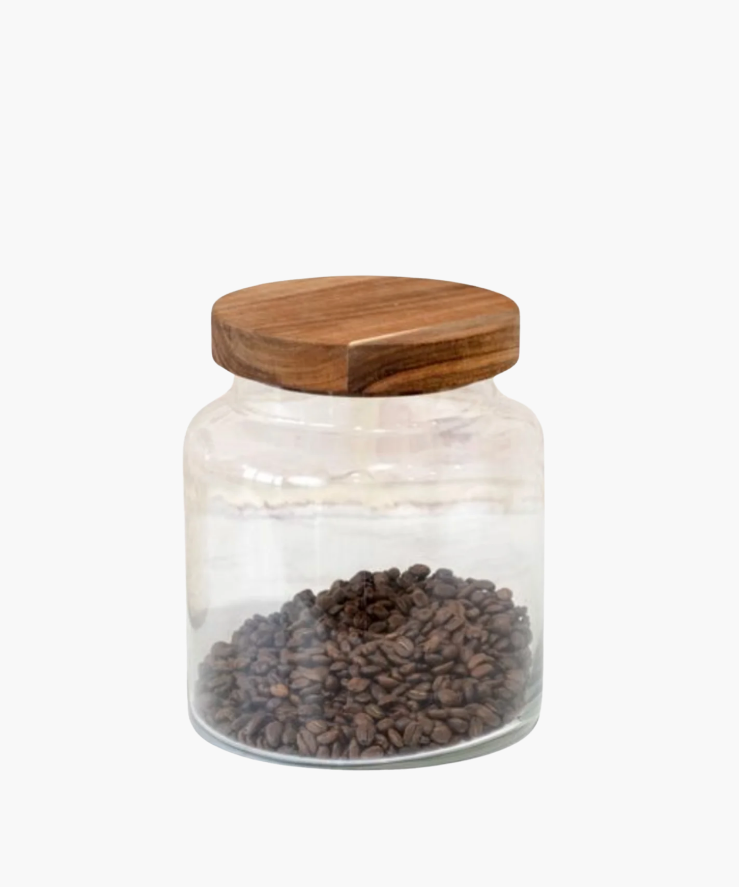 A clear glass jar with a wooden lid, half-filled with dark brown coffee beans. The clean, minimalist design conveys a rustic, cozy feel. | Wildwood Home Co.
