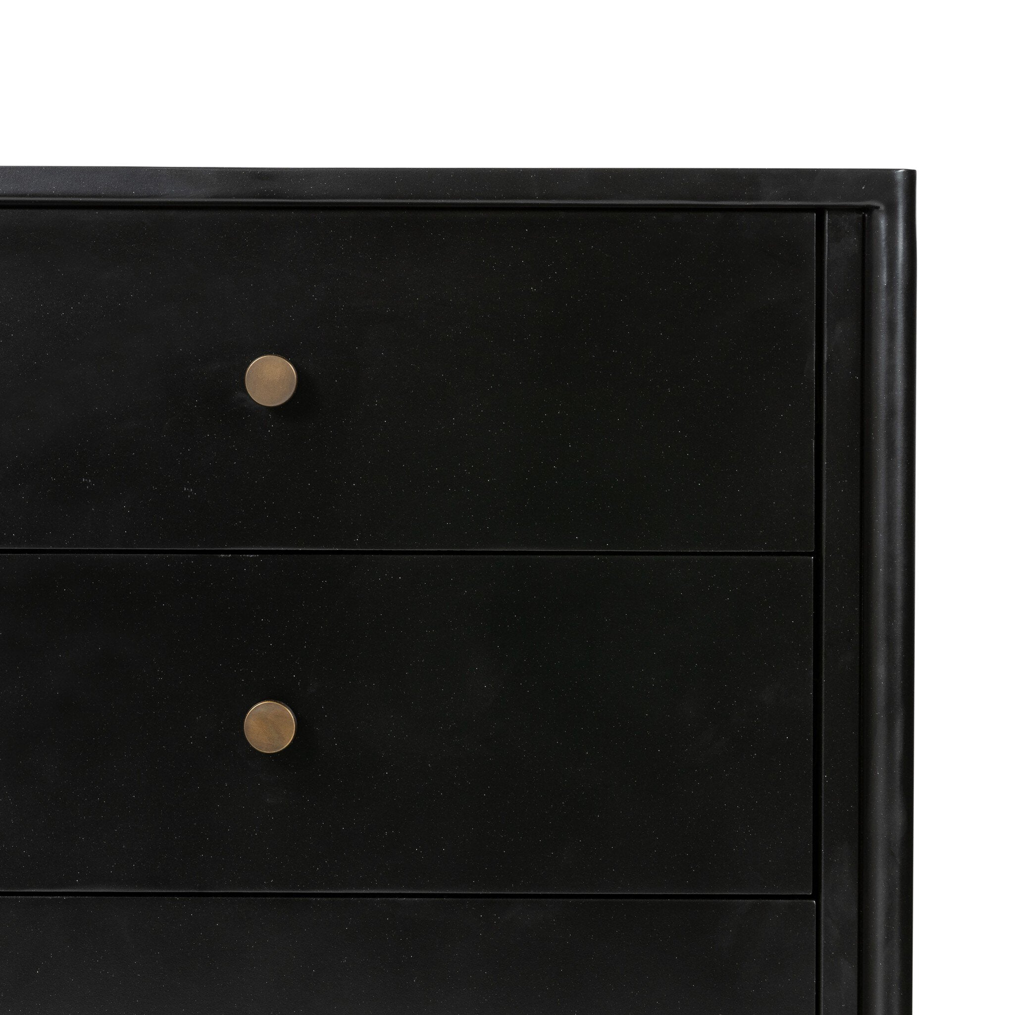 Close up of a black dresser with three drawers on a white background.