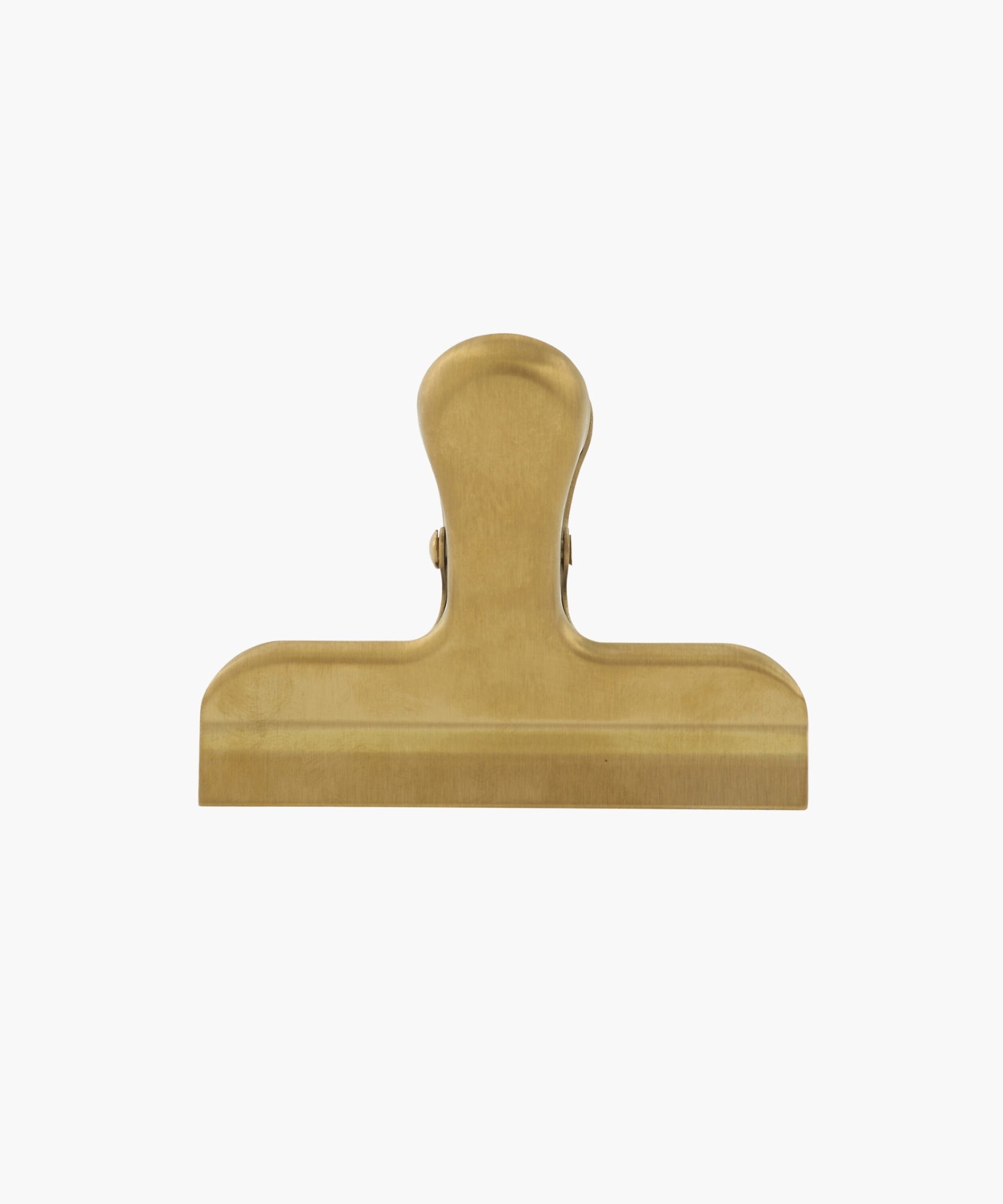 A gold-colored metal binder clip. The clip is large, with a smooth finish, conveying a utilitarian feel. | Wildwood Home Co.