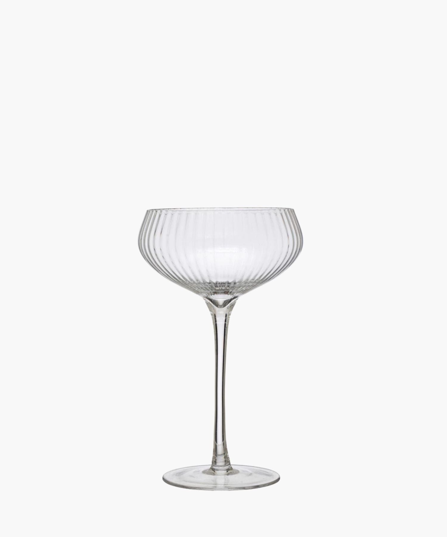 Elegant, clear glass coupe with vertical ridges, featuring a wide, shallow bowl and a tall stem. It exudes sophistication and vintage charm. | Wildwood Home Co.