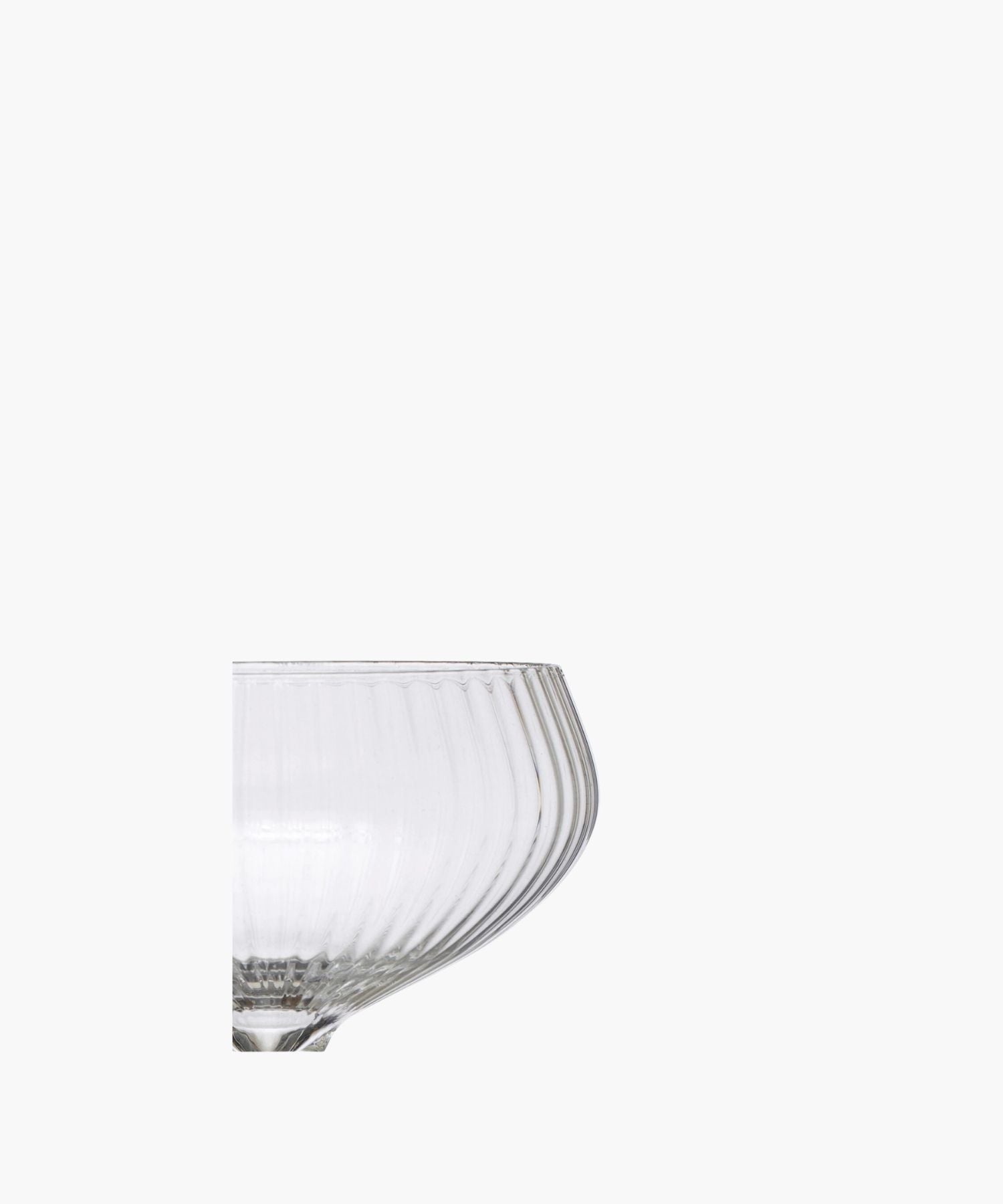 A detailed picture of a clear glass coupe highlighting the vertical ridges. It exudes sophistication and vintage charm. | Wildwood Home Co.