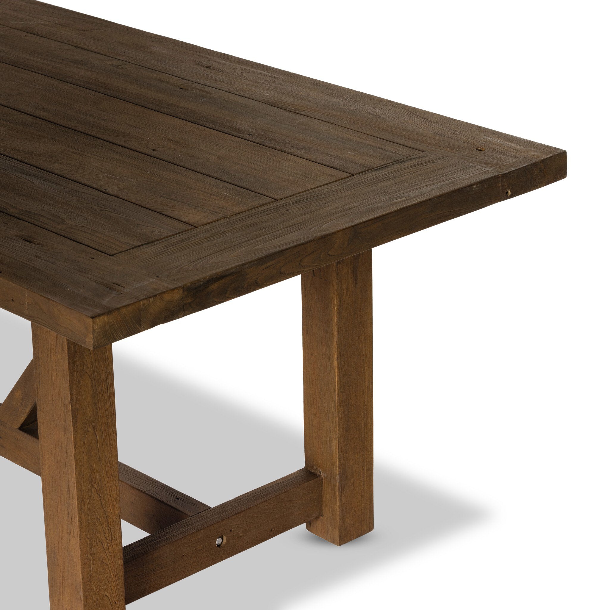 Trestle-style dining table made from reclaimed teak on a white background.