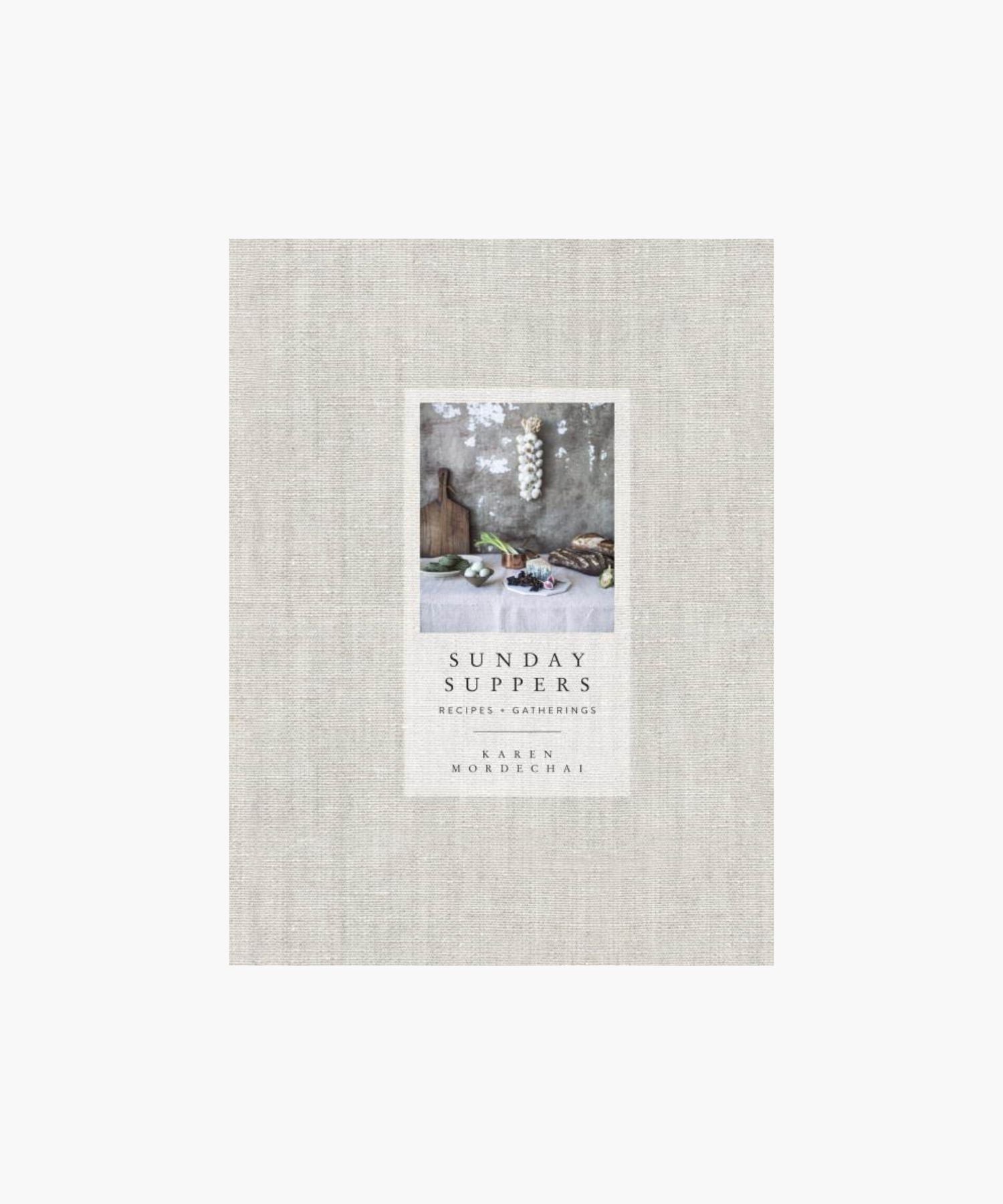Cookbook cover titled "Sunday Suppers" by Karen Mordechai features rustic kitchen items on a table against a textured wall, evoking a cozy, inviting scene. | Wildwood Home Co.