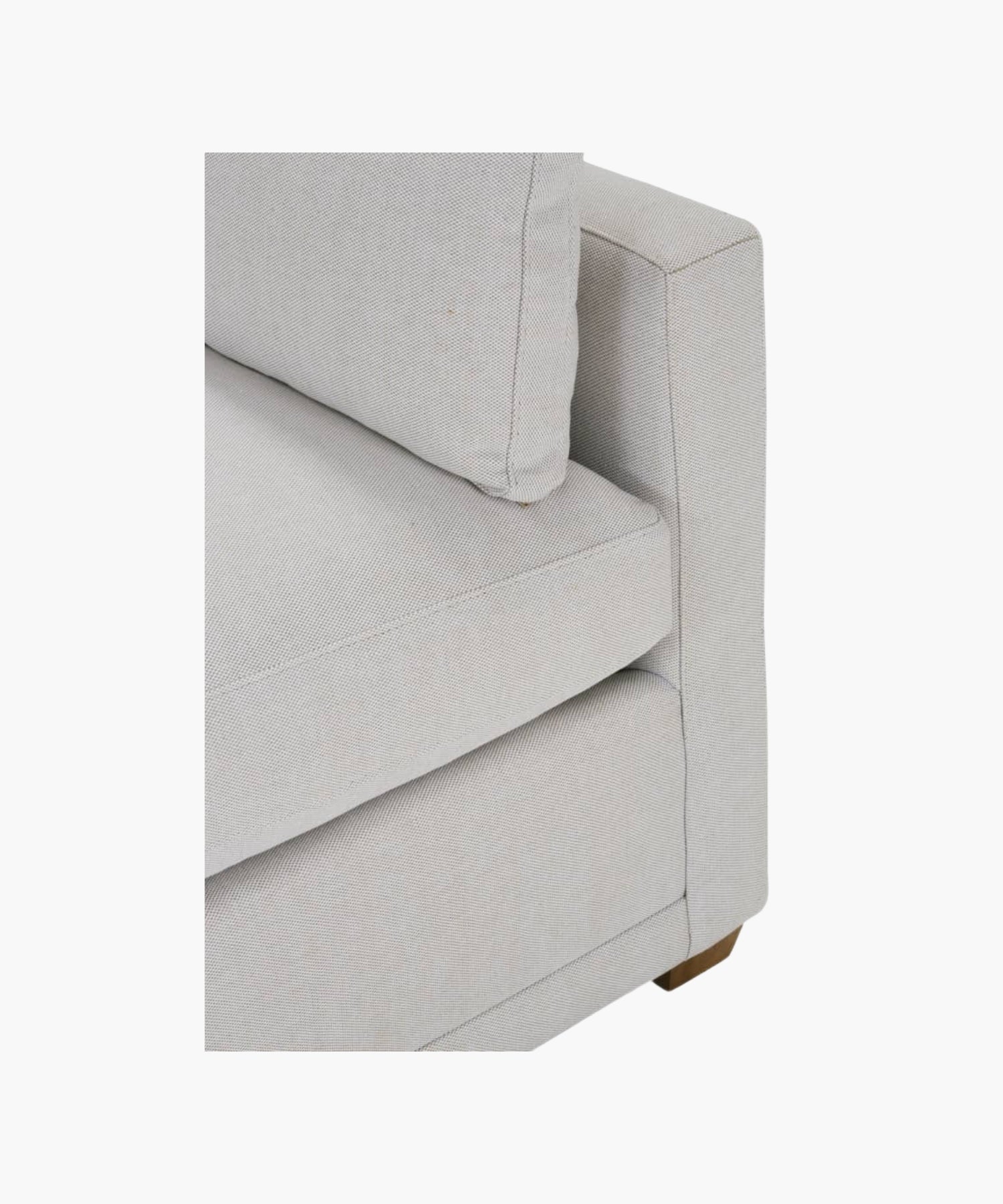 Close up of a gray sofa on a white background.