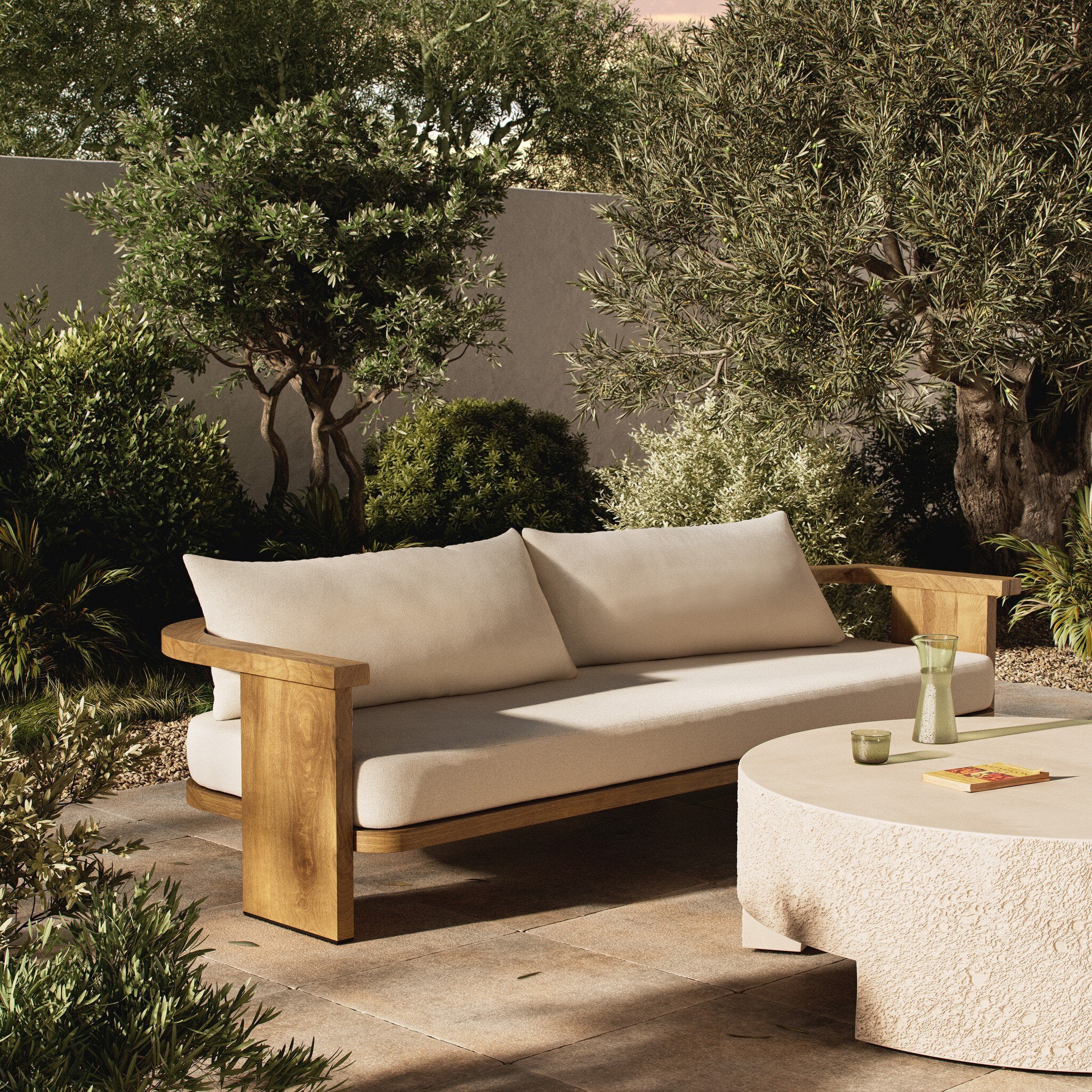 Outdoor patio set with wooden frame and beige cushions in a garden setting. | Wildwood Home Co.