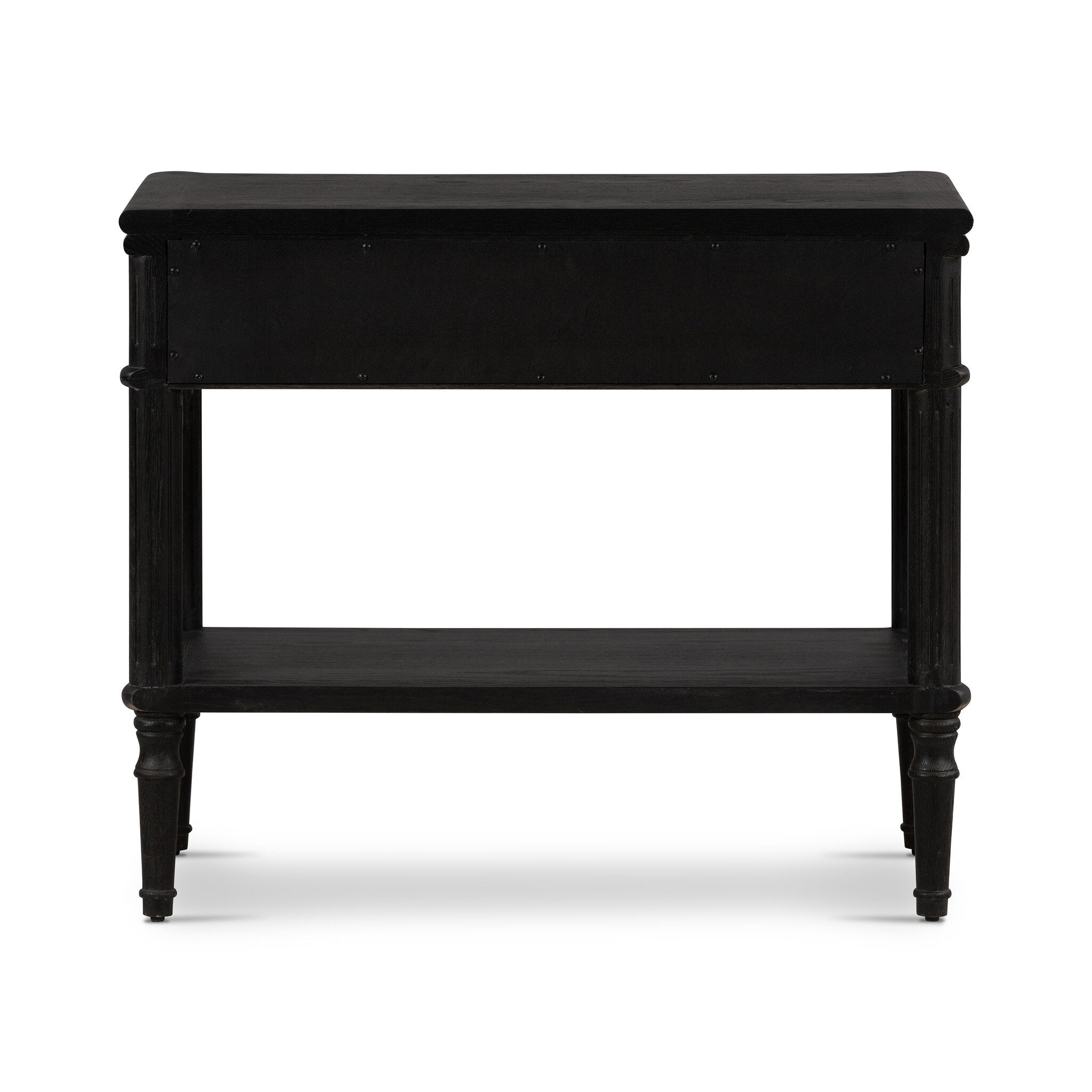 The back of a distressed black oak nightstand with a drawer and a shelf on a white background.