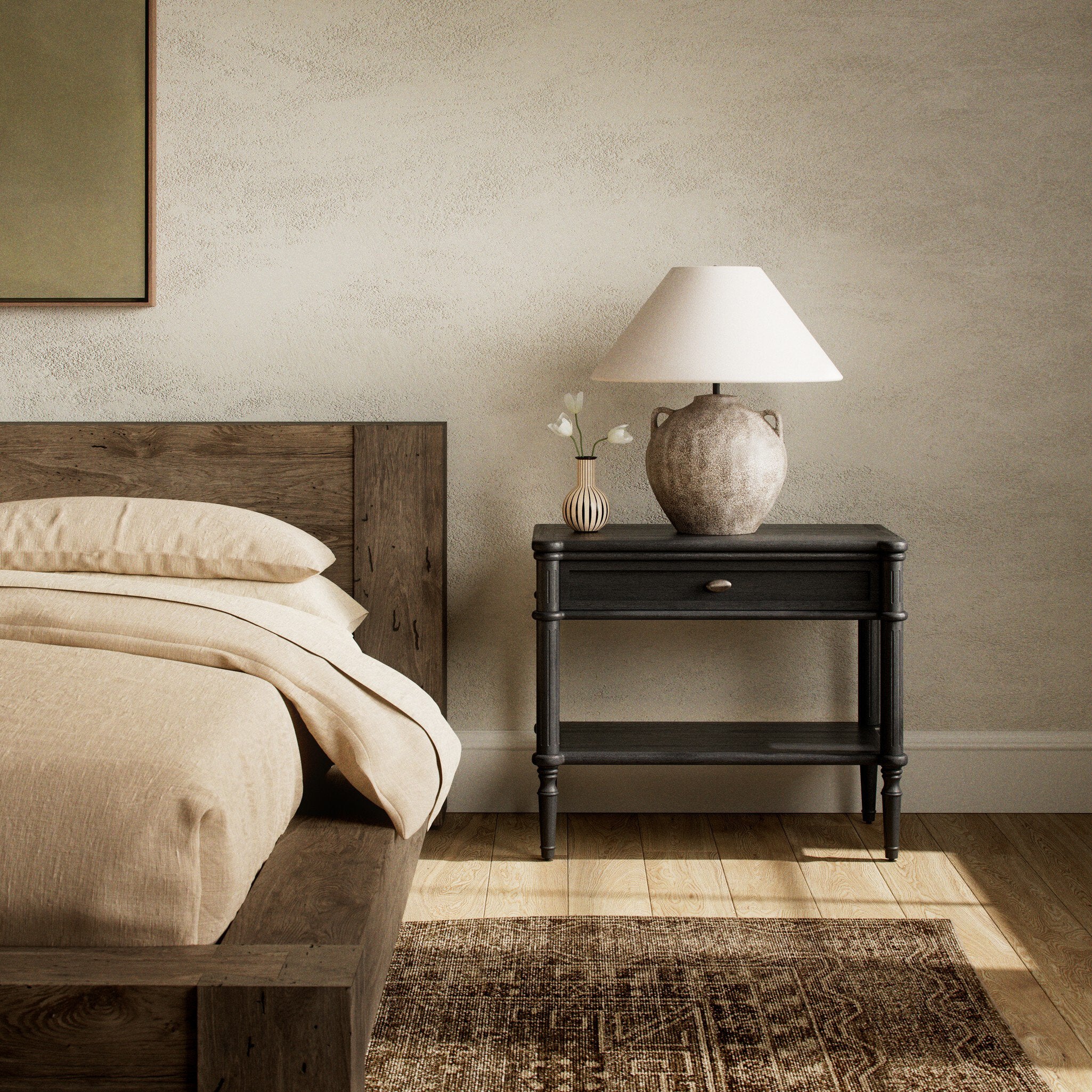 Bedroom with wooden bed, black nightstand, and lamp. | Wildwood Home Co.