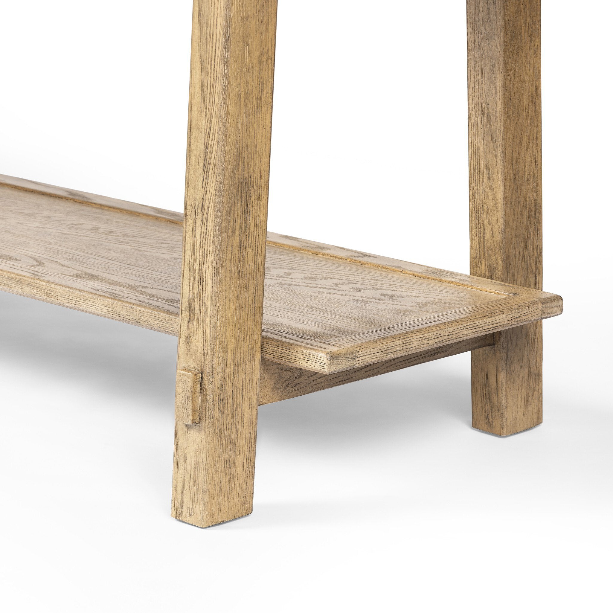 Close up of a wooden console table with a rustic finish on a white background.