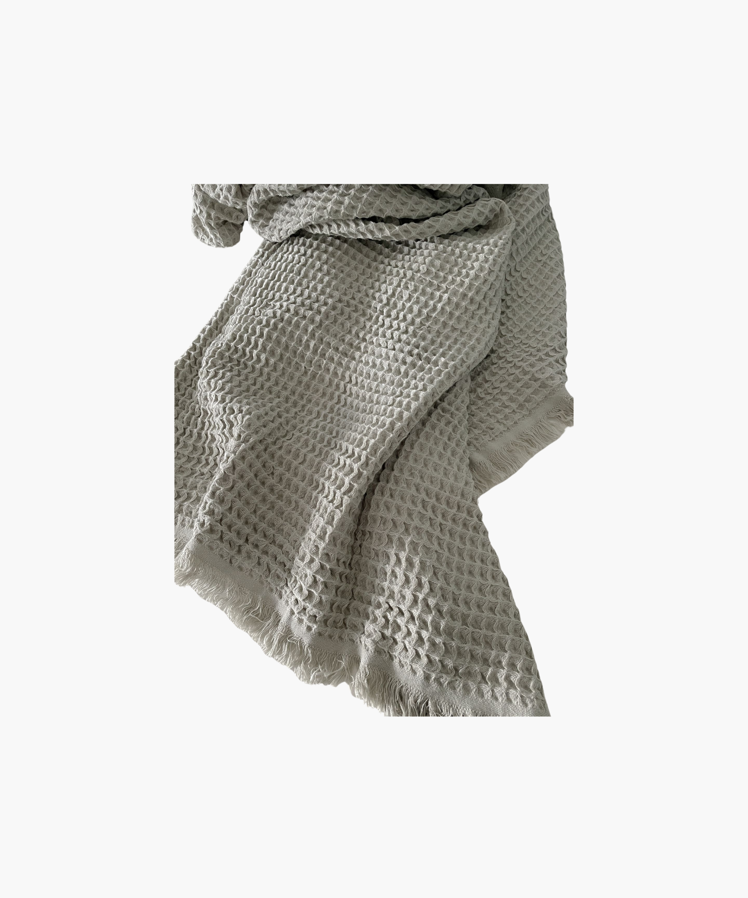 Olive waffle-textured throw blanket with fringed edges, laid flat. The soft material conveys a cozy, inviting feel. Suitable for any living room or bedroom.