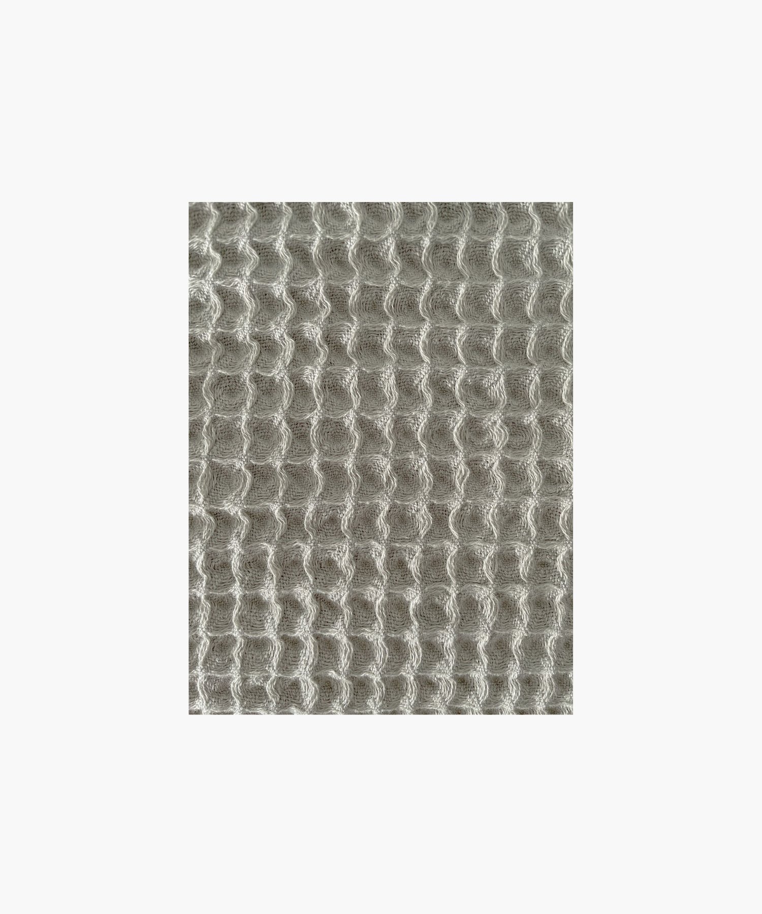 Close up of the olive waffle-textured throw blanket highlighting the texture and color. The soft material conveys a cozy, inviting feel. Suitable for any living room or bedroom.