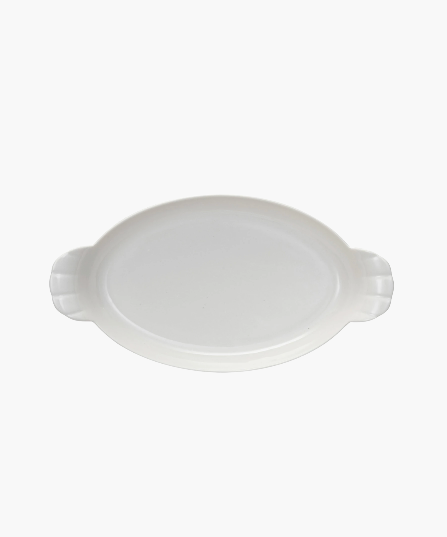 Oval white ceramic dish with two ridged handles. The dish is empty and centered on a plain white background, conveying simplicity and elegance. | Wildwood Home Co.