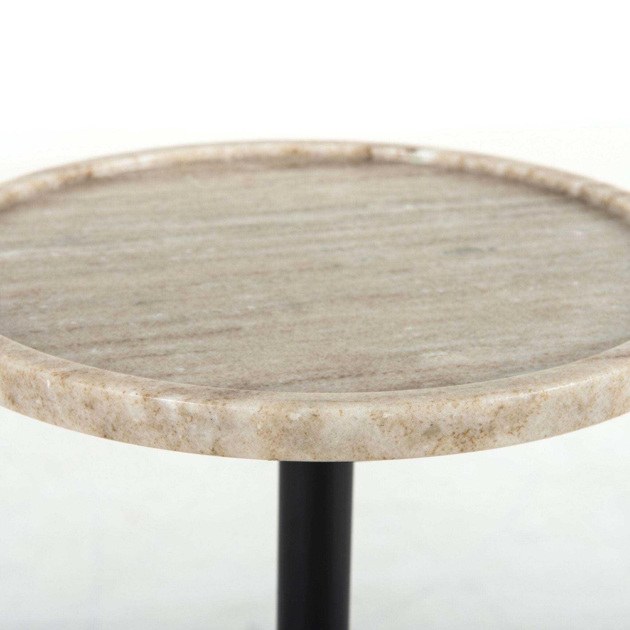 Close up of an accent table highlighting its tray like round top on a white background.