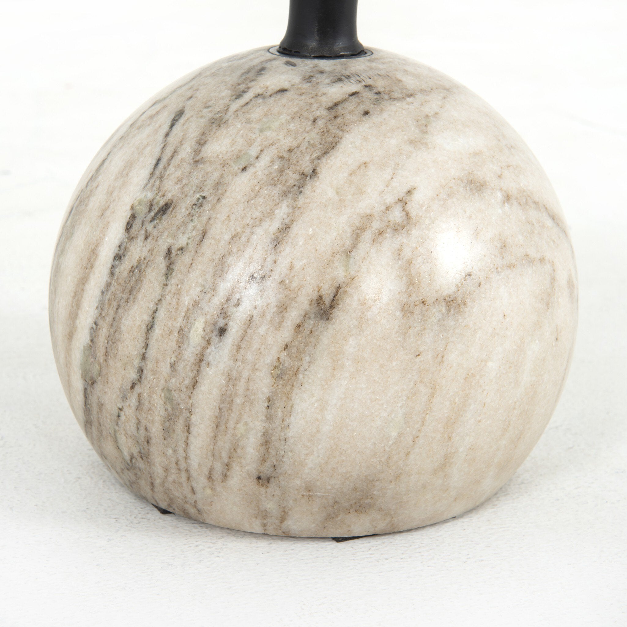 Close up of an accent table with a dramatic marble base.
