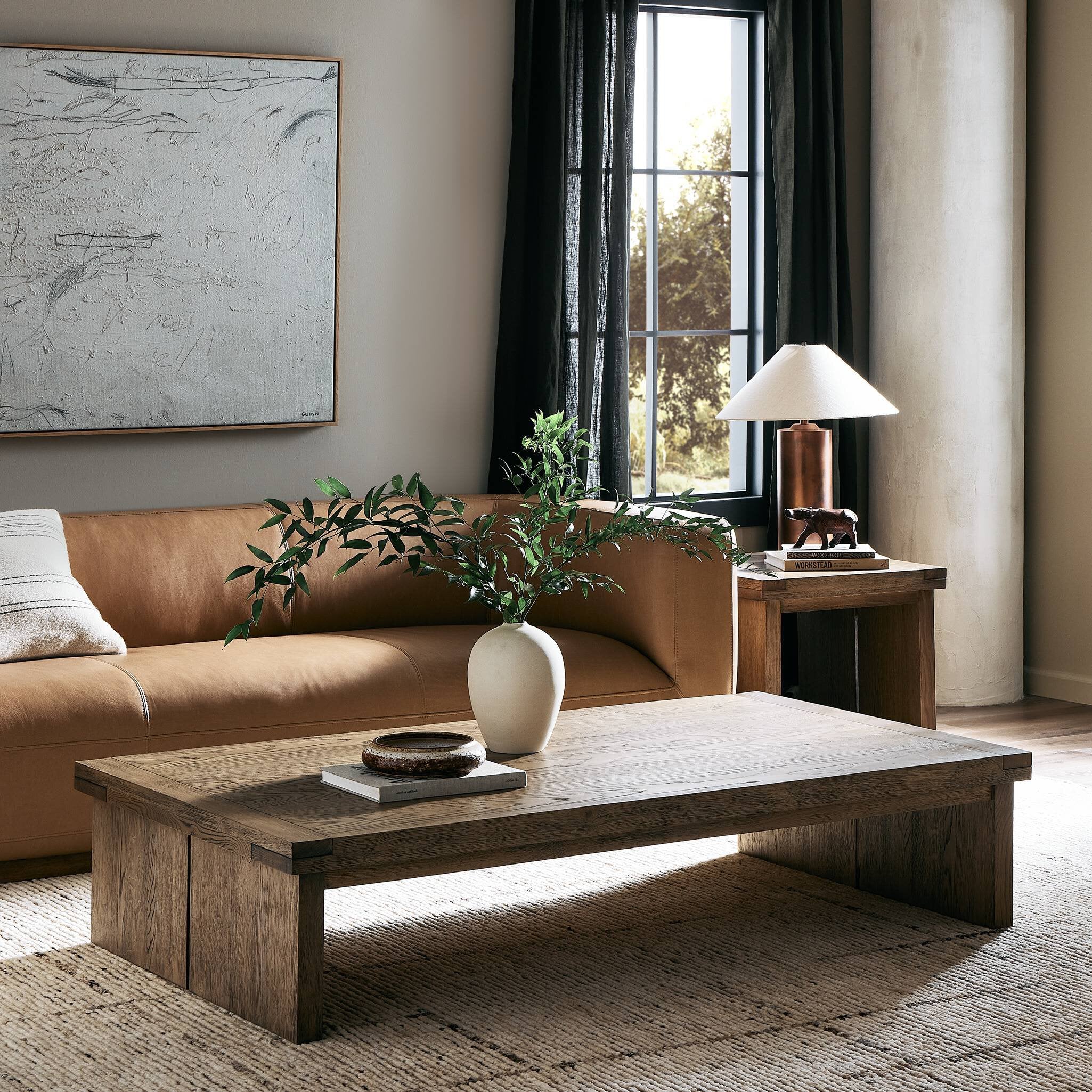 Living room with a brown sofa, wooden coffee table, and decorative items. | Wildwood Home Co.