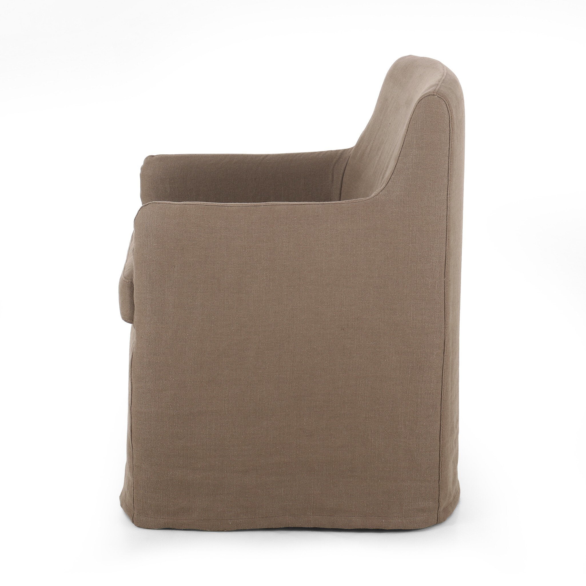Side profile of a slipcovered dining chair in an earthy mushroom brown hue with rounded arms on a white background. 