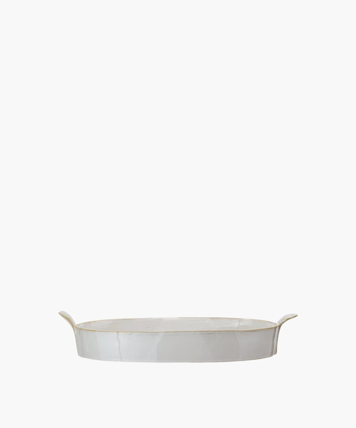Oval white ceramic stoneware baker with slightly raised, flared handles on each end. The baker has a glossy finish, conveying a minimalist, elegant design. | Wildwood Home Co.