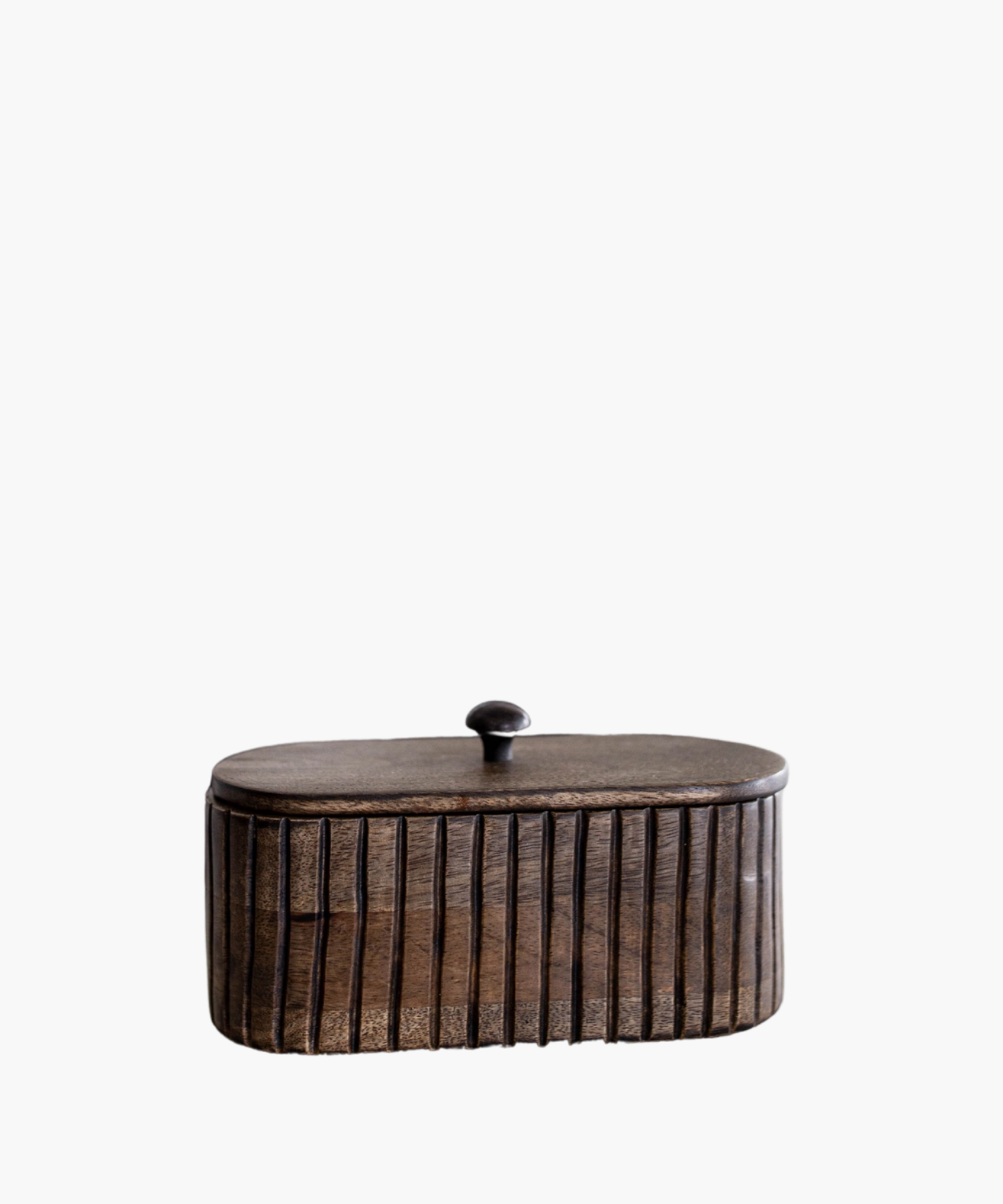 A dark wooden oval box with vertical grooves and a small round handle on top. The wood's texture feels rustic, conveying a warm, vintage aesthetic.