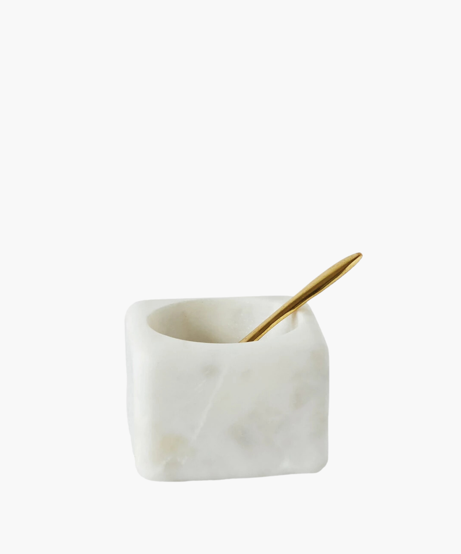 A white marble square salt cellar with a smooth finish and a small, elegant golden spoon resting inside, conveying a sense of luxury and simplicity. | Wildwood Home Co.