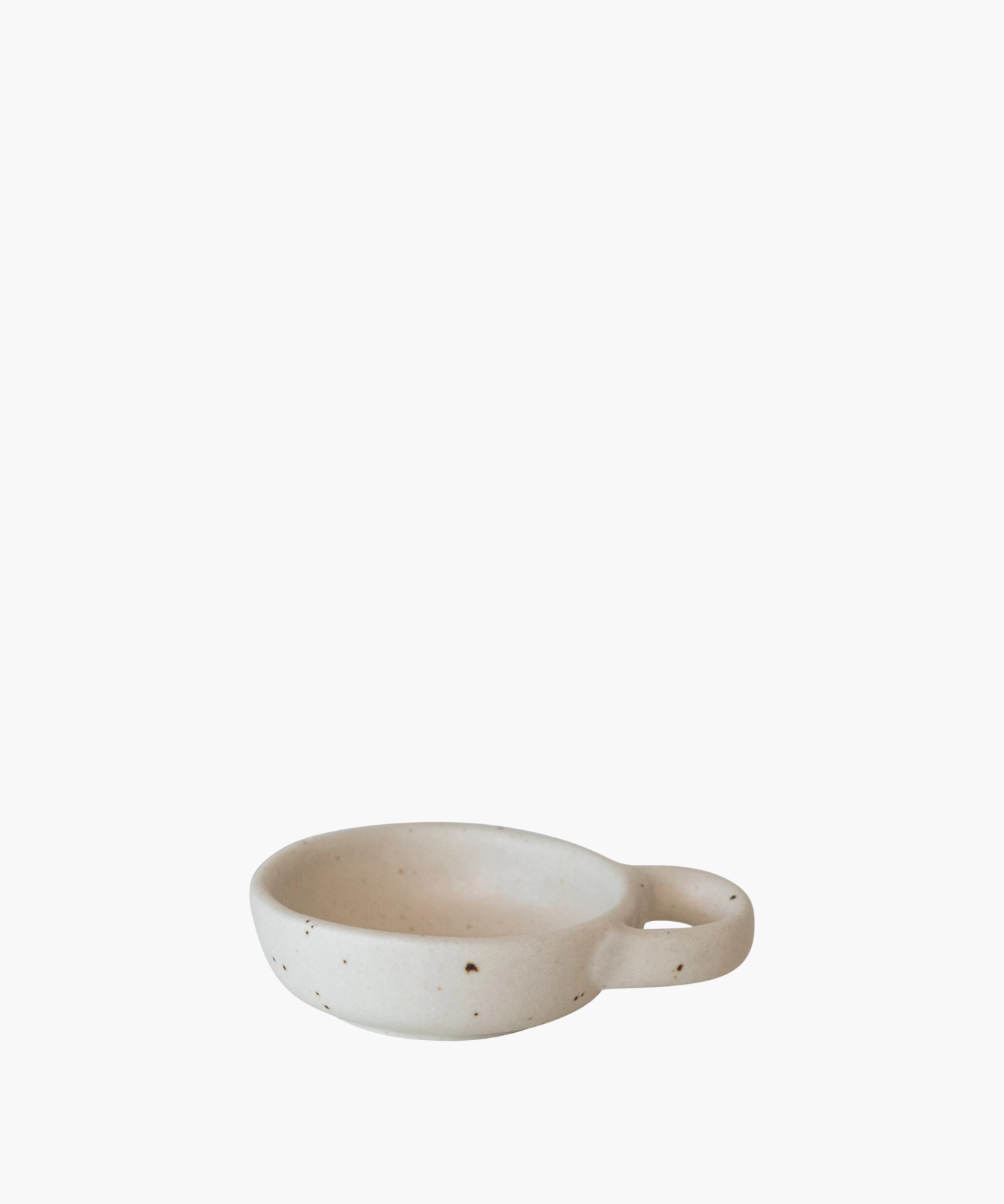 Minimalist ceramic bowl with speckled texture and a round handle on the right side. Its earthy tones convey simplicity and elegance. | Wildwood Home Co.
