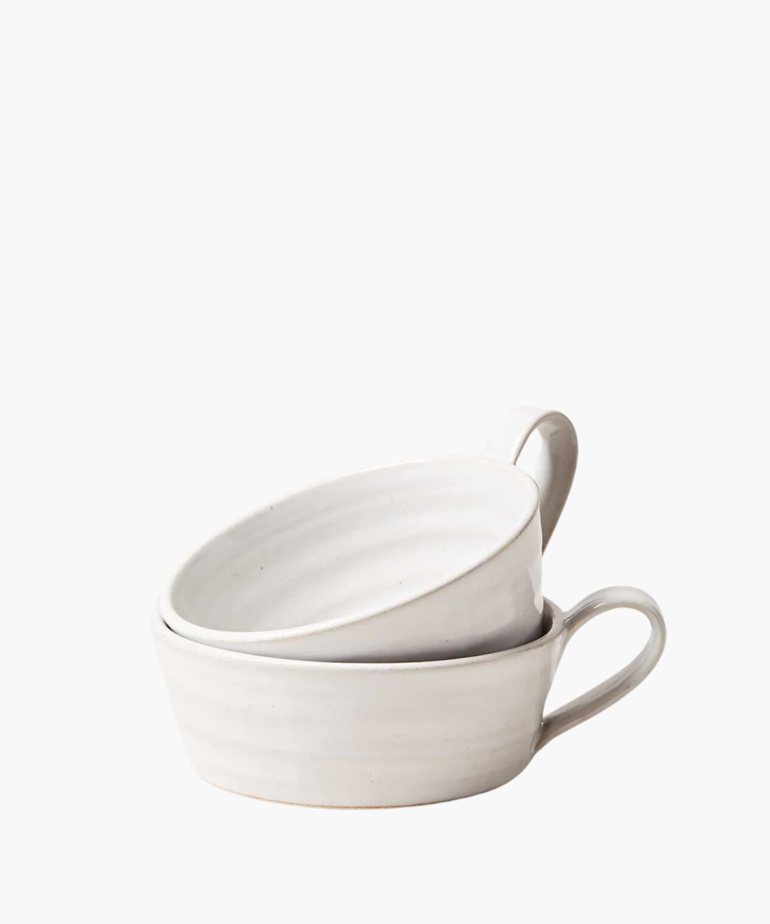 Two simple white ceramic mugs stacked with a single loop handle on the right. The bowl has a smooth, matte finish and conveys a minimalist, elegant design. | Wildwood Home Co.