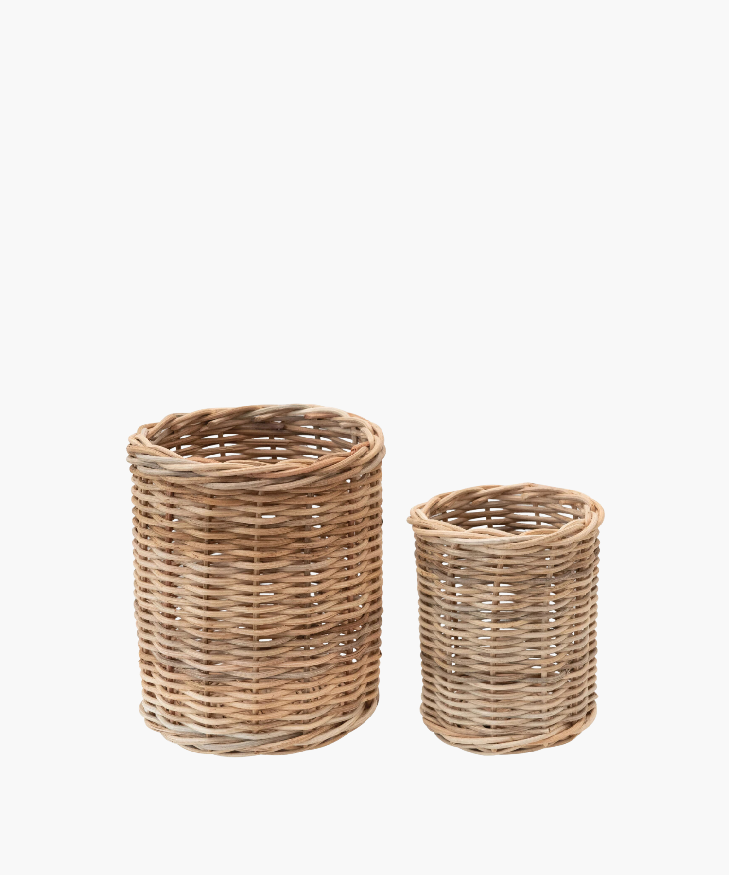Two round wicker basket containers are shown against a white background. The larger basket is on the left, and a smaller one is on the right. Both have a natural, rustic appearance. | Wildwood Home Co.